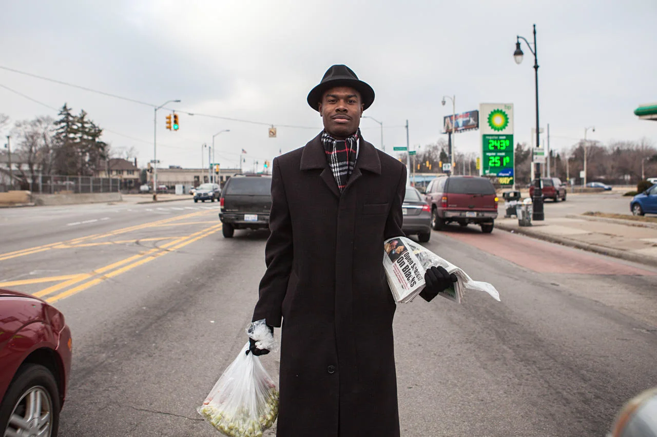 Darryl X. Walker sells produce and newspapers at the corner of Grand River Avenue and Southfield Road.