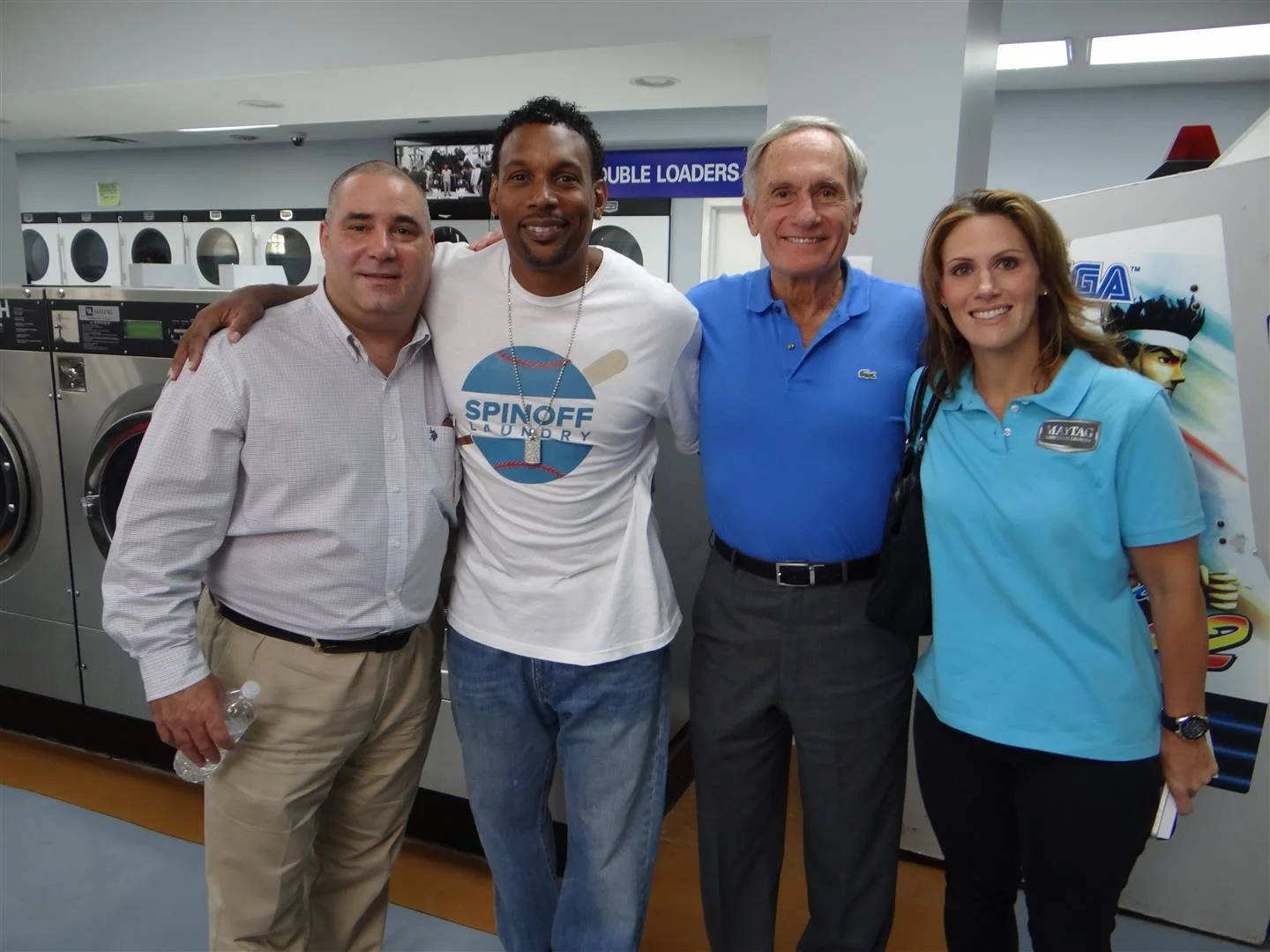 Greg Paci, sales representative for Equipment Marketers; Ernest (Bo) Donaldson, owner of Spin Off Laundry; Dick LaMaina, president of Equipment Marketers; and Katie Weitzman, assistant vice president of Equipment Marketers, celebrate the recent grand opening of Spin Off Laundry. (Photo: Maytag Commercial Laundry)