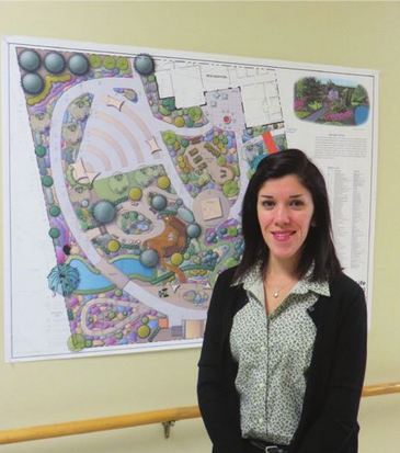 Iowa State University graduate student Alejandra Feliciano stands next to her team’s proposal for the On With Life therapy garden.