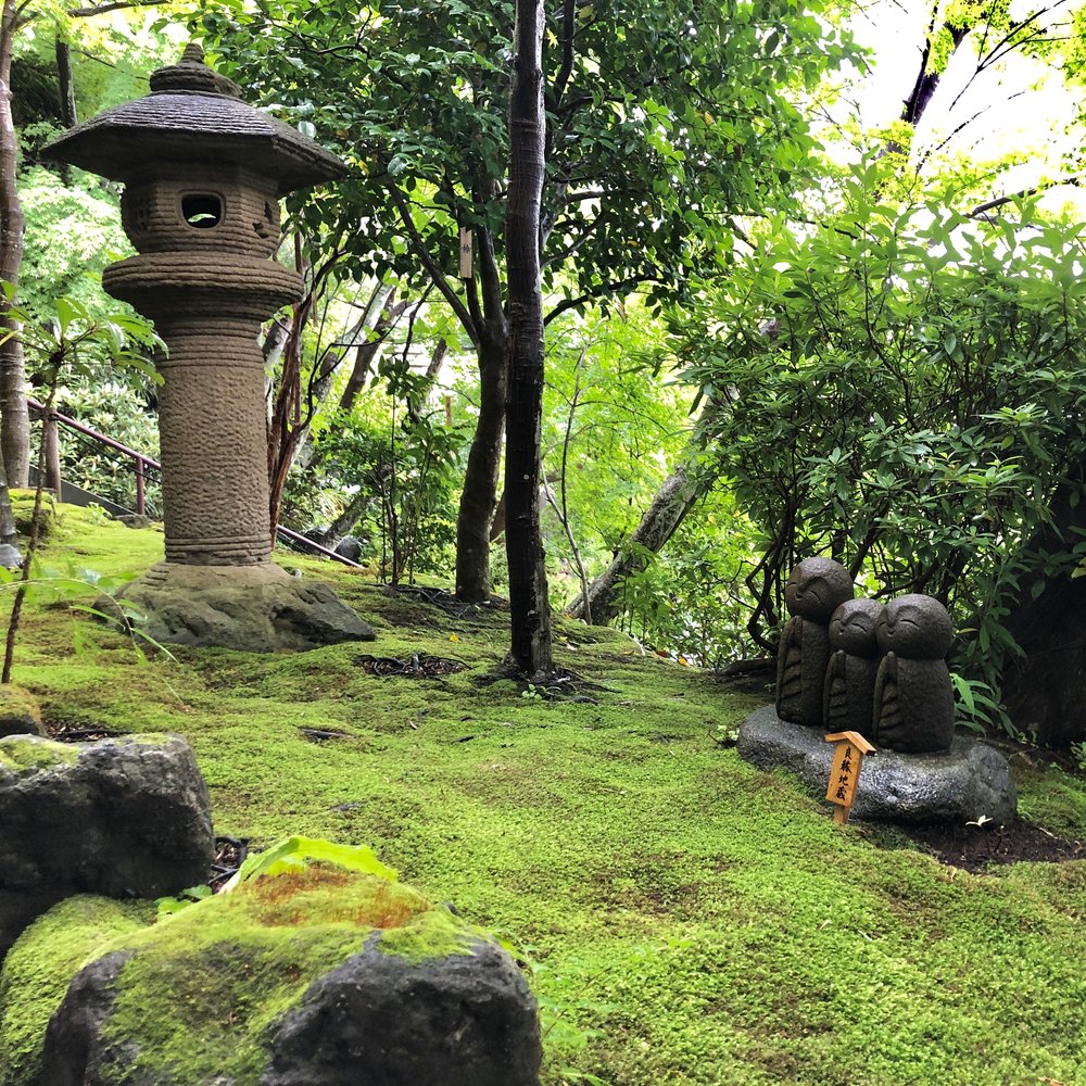 Jizo statues on carefully weeded moss floors.