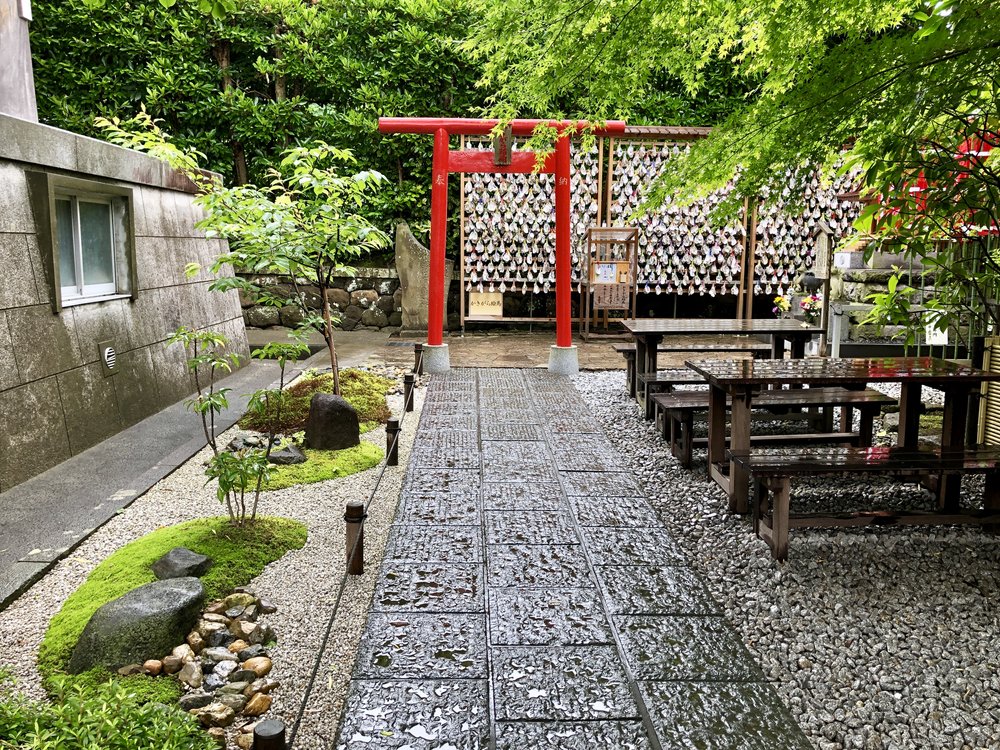 Rock (zen) garden at the Ksitigarbha Pavilion. You can see the wall of seashell prayers past the vermillion torii gate.