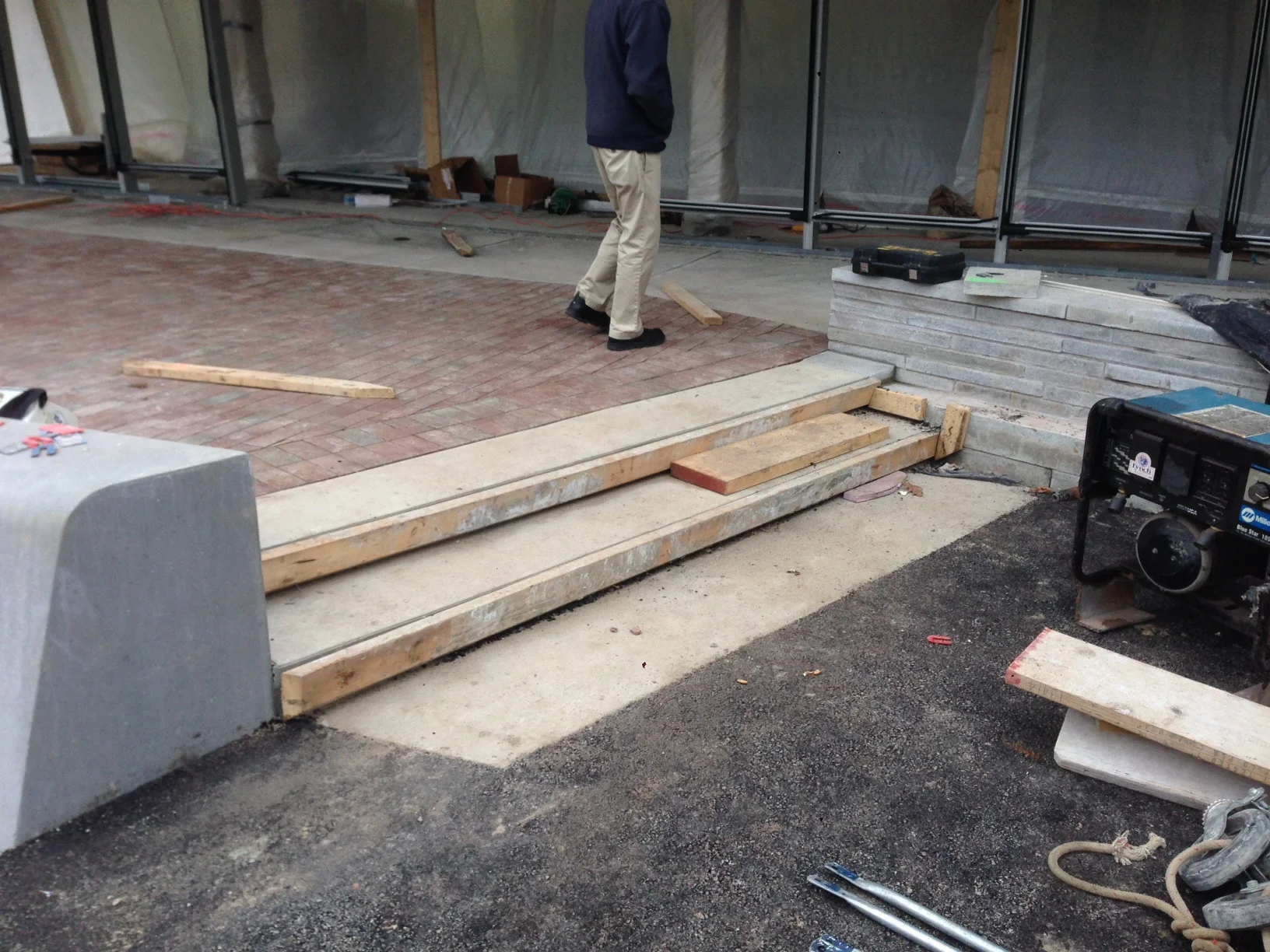 Broad concrete stairs connect the two seatwalls.