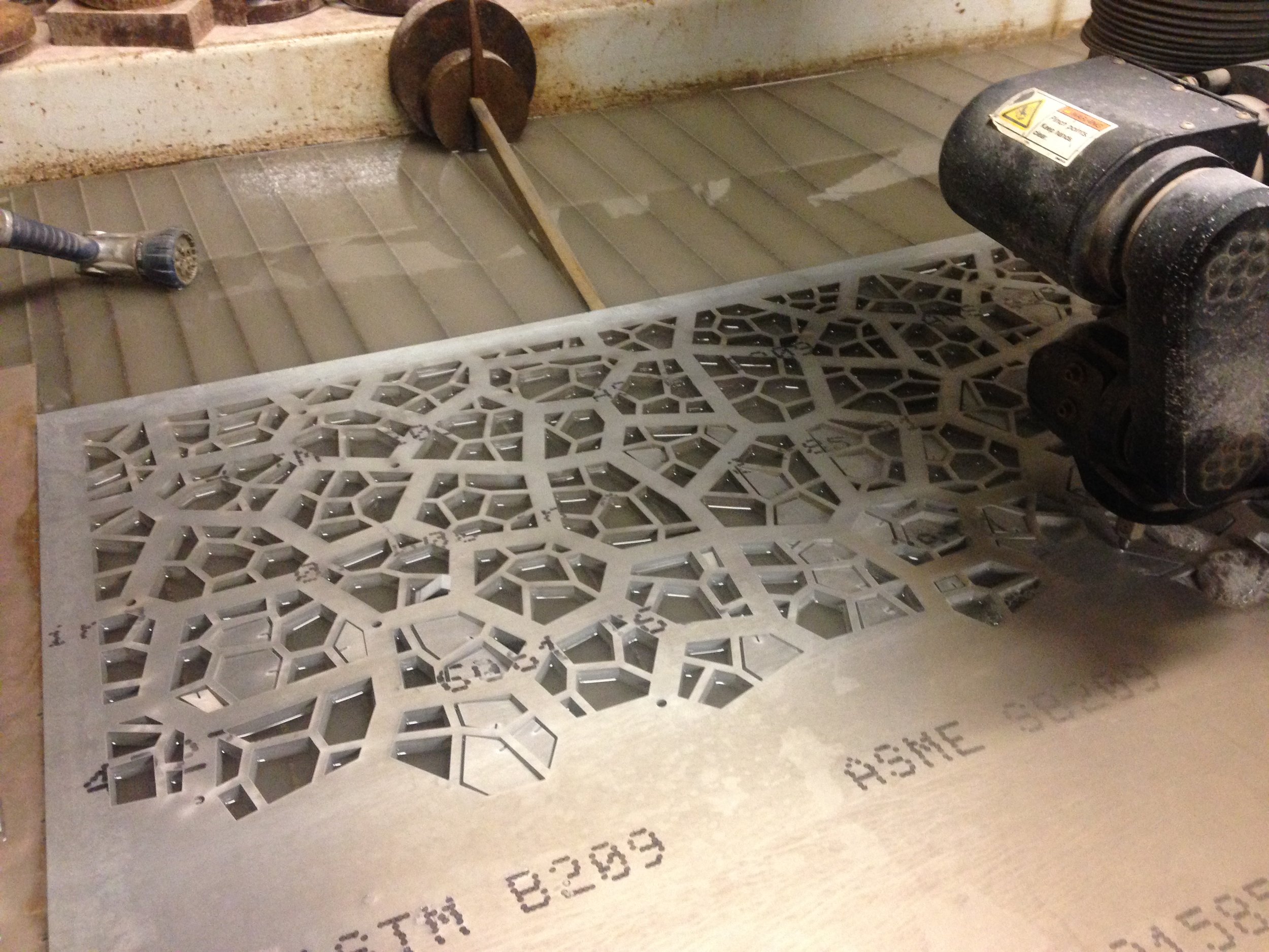  Waterjet cutting the pattern from solid aluminum. 