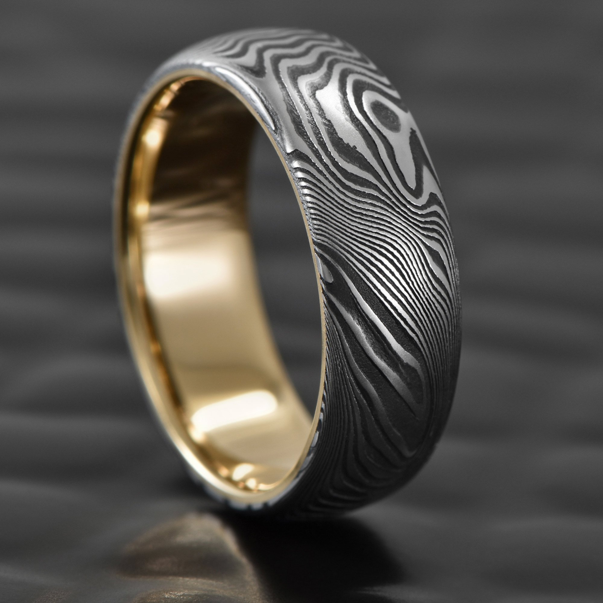 Old-Growth-Damascus-Steel-Wedding-Ring-Domed-Gold-Sleeve.jpg