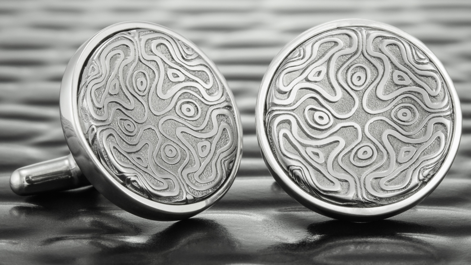  A matching pair of custom cufflinks for the groom. 