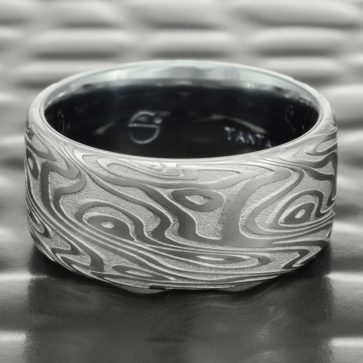swirling steel damascus hand crafted wedding band tantalum liner
