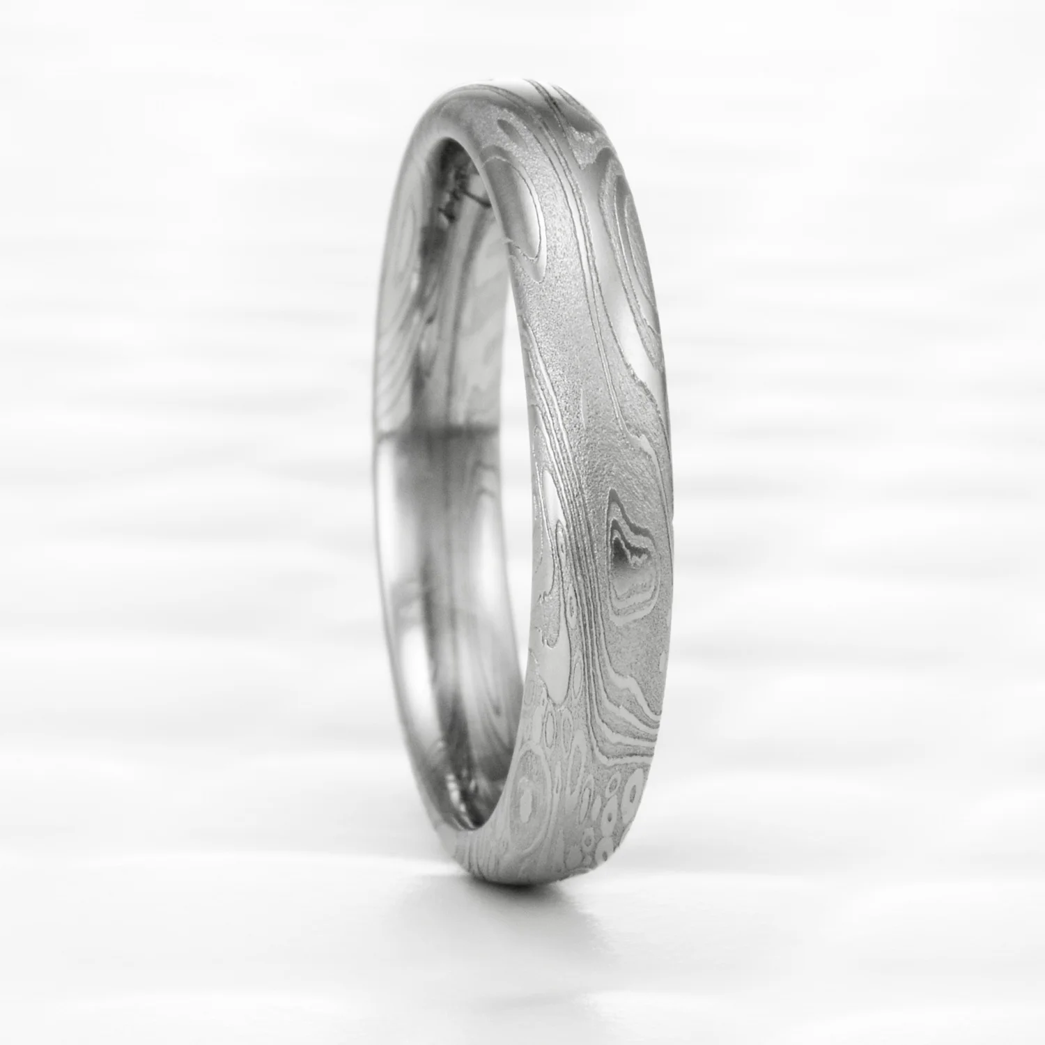narrow small domed patterned stainless damascus unique engagement ring