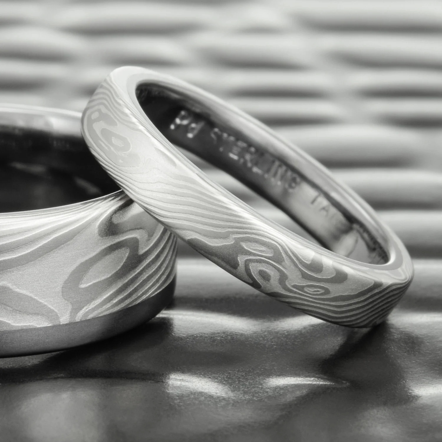 handcrafted unique nature inspired flowing patterned mens mokume silver palladium tantalum rail band womens wedding set thin