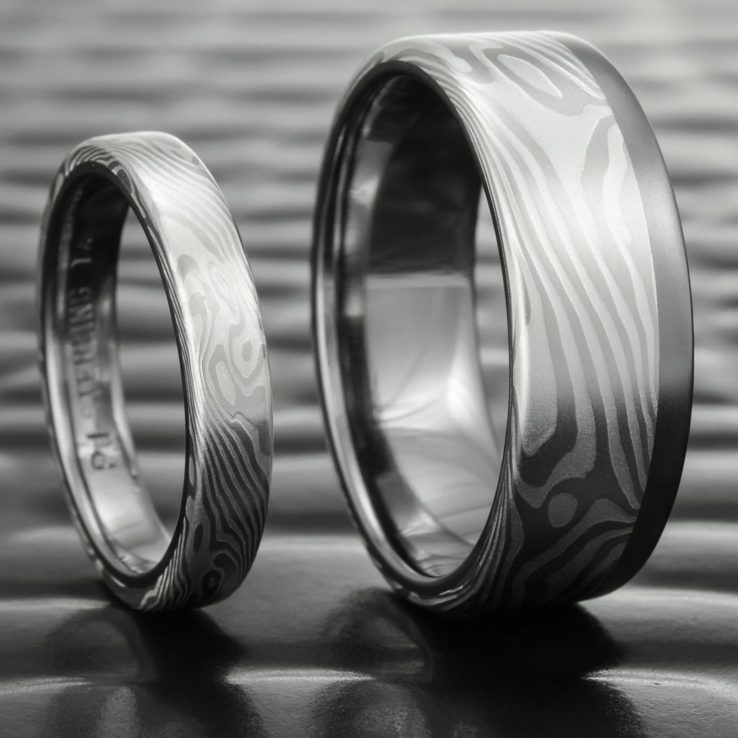 handmade unique nature inspired flowing patterned mens mokume silver palladium tantalum rail band womens wedding set