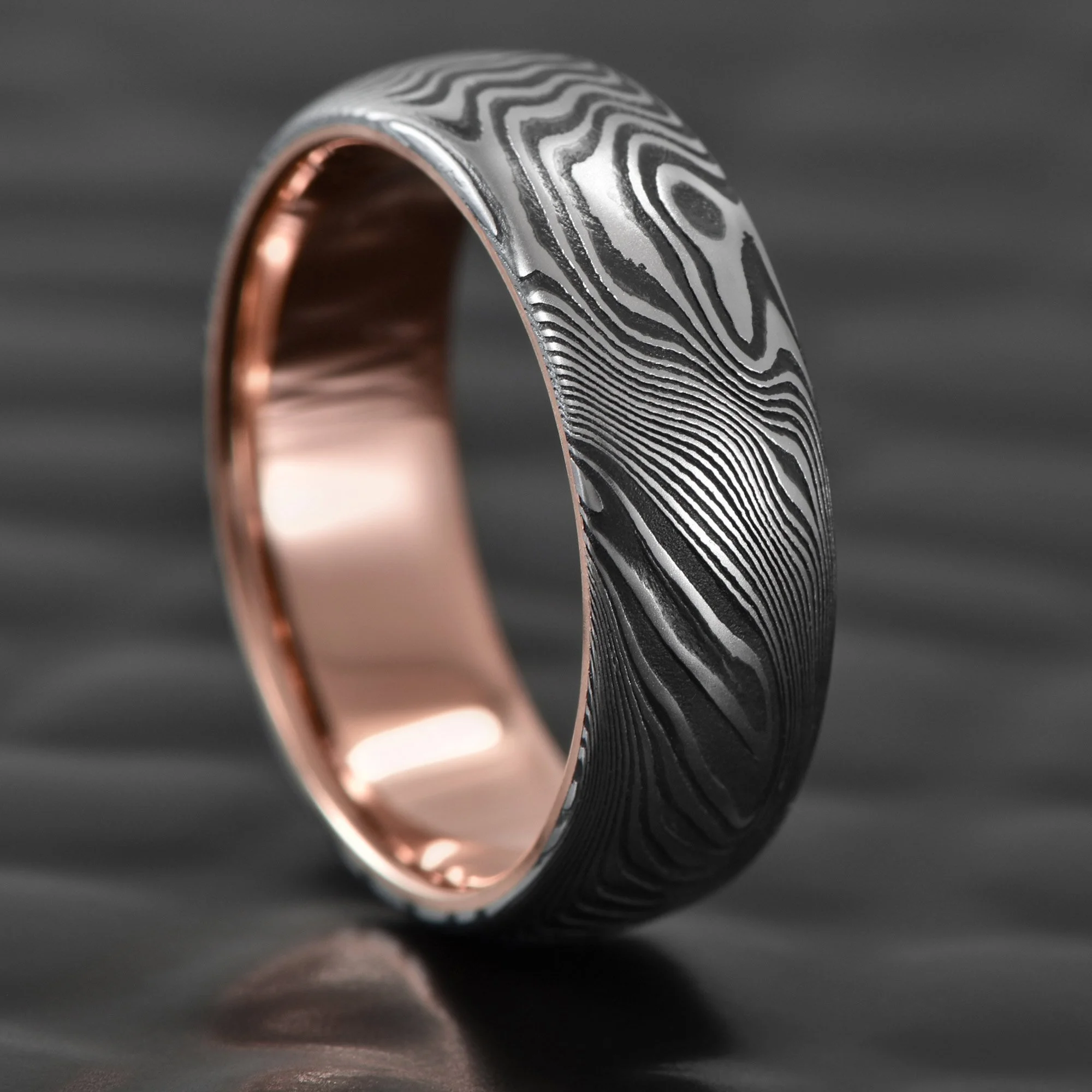 Damascus Steel Wedding Band with 14K Rose Gold Liner and Dark Fire Oxide Finish  |  OLD GROWTH