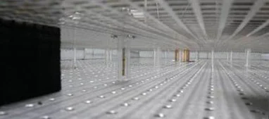 Experimental configuration. A 4'x8' optical table rimmed with graphite impregnated absorbers and a subwavelength mesh on top. The illiumination probe is shown in the foreground while the cloaked object is shown in the background.