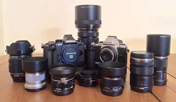 My tools and toys - The Olympus OM-D E-M5 and E-M1 surrounded by my favourite primes and pro zooms.
