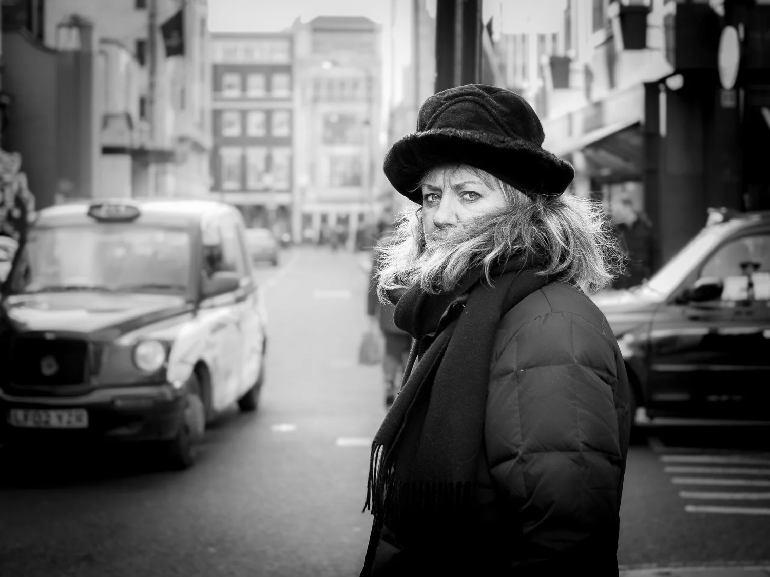 Standing at a red light waiting to cross the street I took a few side-steps to get closer to this woman. I waited for the lights to turn amber before raising the camera and making a frame. With so much going on around us all my subject could do was …