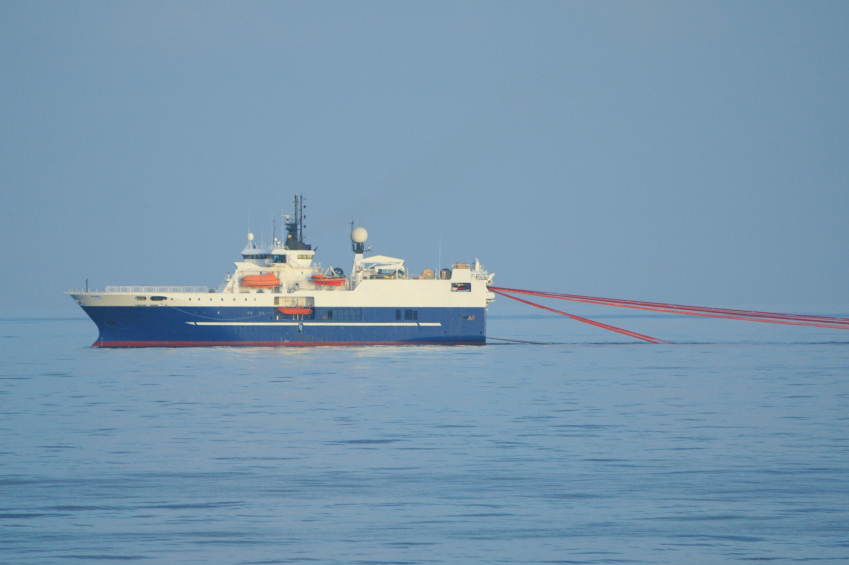 Photo of a seismic survey vessel towing hydrophone streamers.