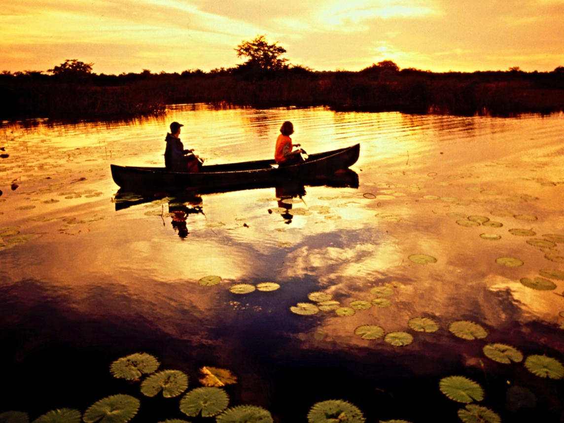 Taking in the dawn by canoe, Lamania Outpost Lodge
