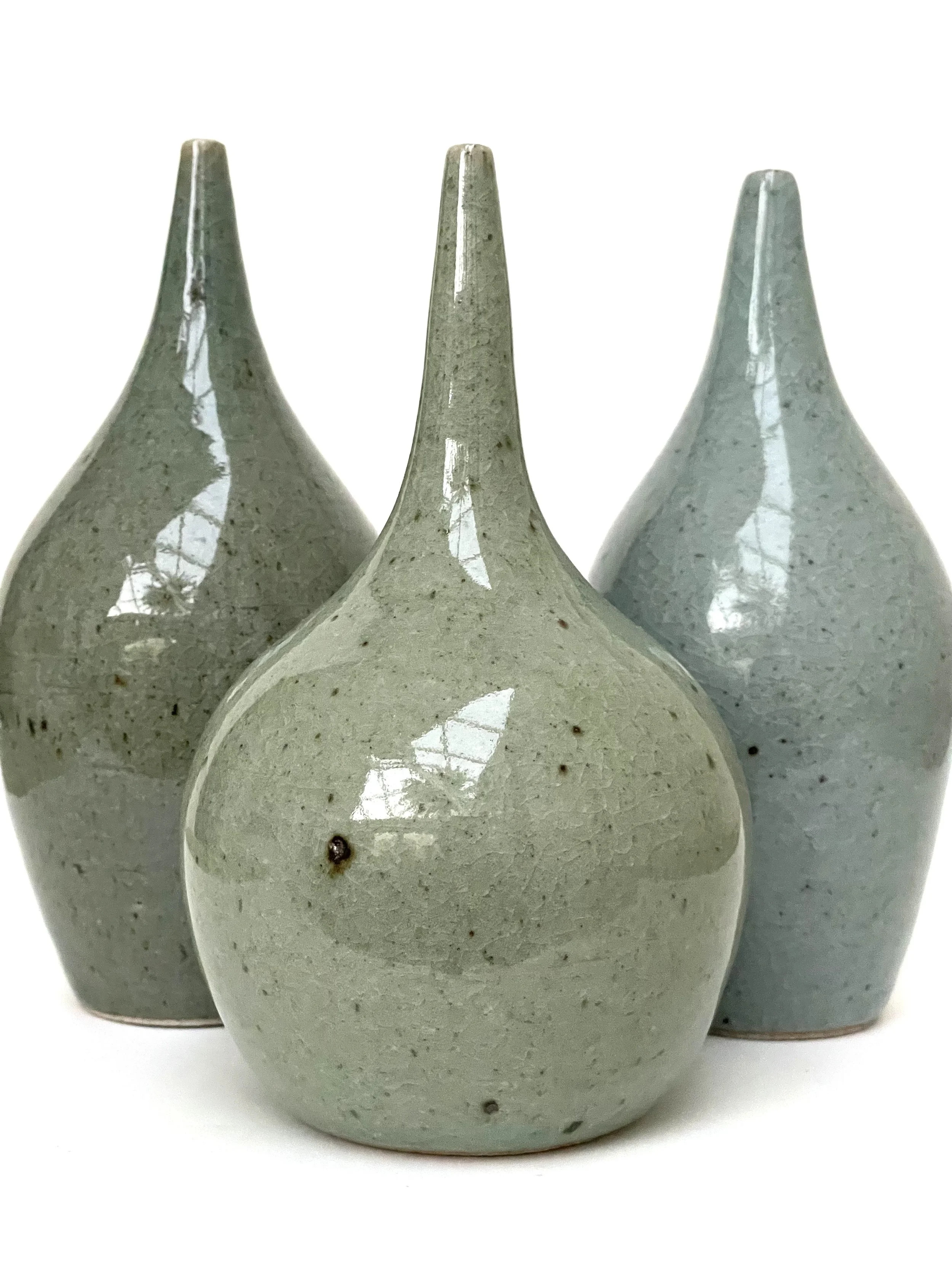 Decorative handmade ceramic long neck bottles in celadon glaze with a crackle finish