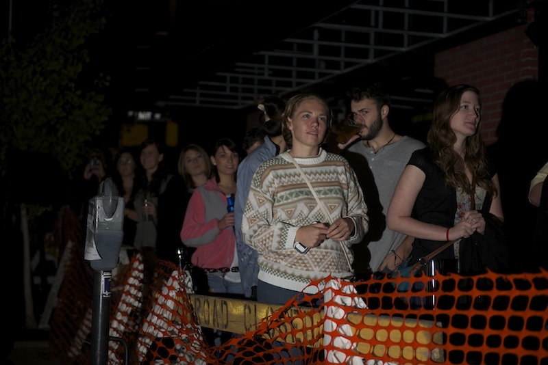 Fans stand behind a barricade on Ninth Street watching band Foster the People perform outside the Blue Note as part of Ninth Street Summerfest Wednesday, October 8, 2014. 
