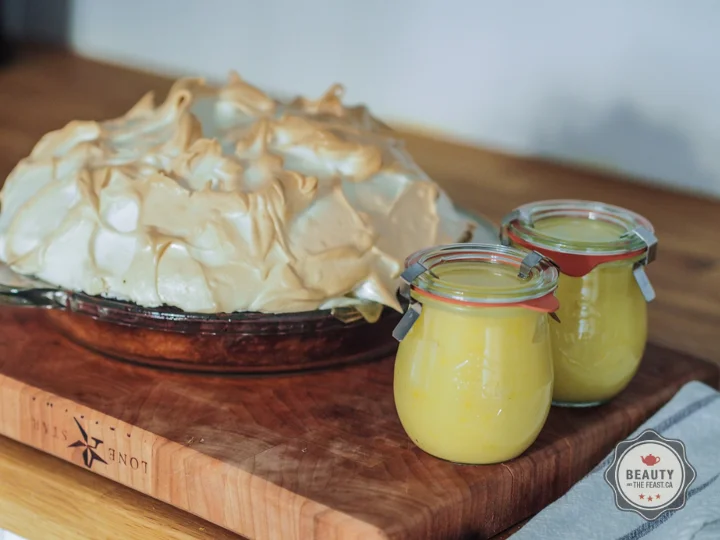 Lemon Meringue Pie with jars of left over lemon curd