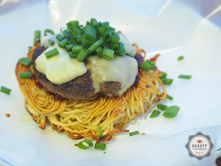 Assembling the two burgers onto the Noodle Buns. I used a Sambal Oelek and Oyster sauce to give a little saltiness and kick... A clean mild mozzaa for some creaminess and a call back to the hamburgers original roots... I think beef, noodles, and gre…