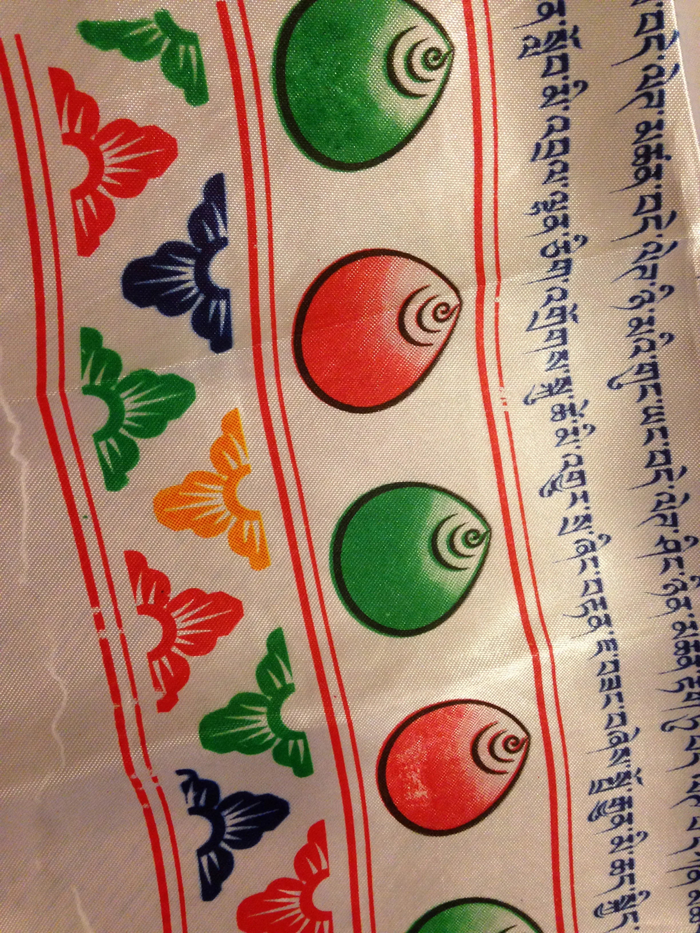 A silk khata scarf with Tibetan mantras.