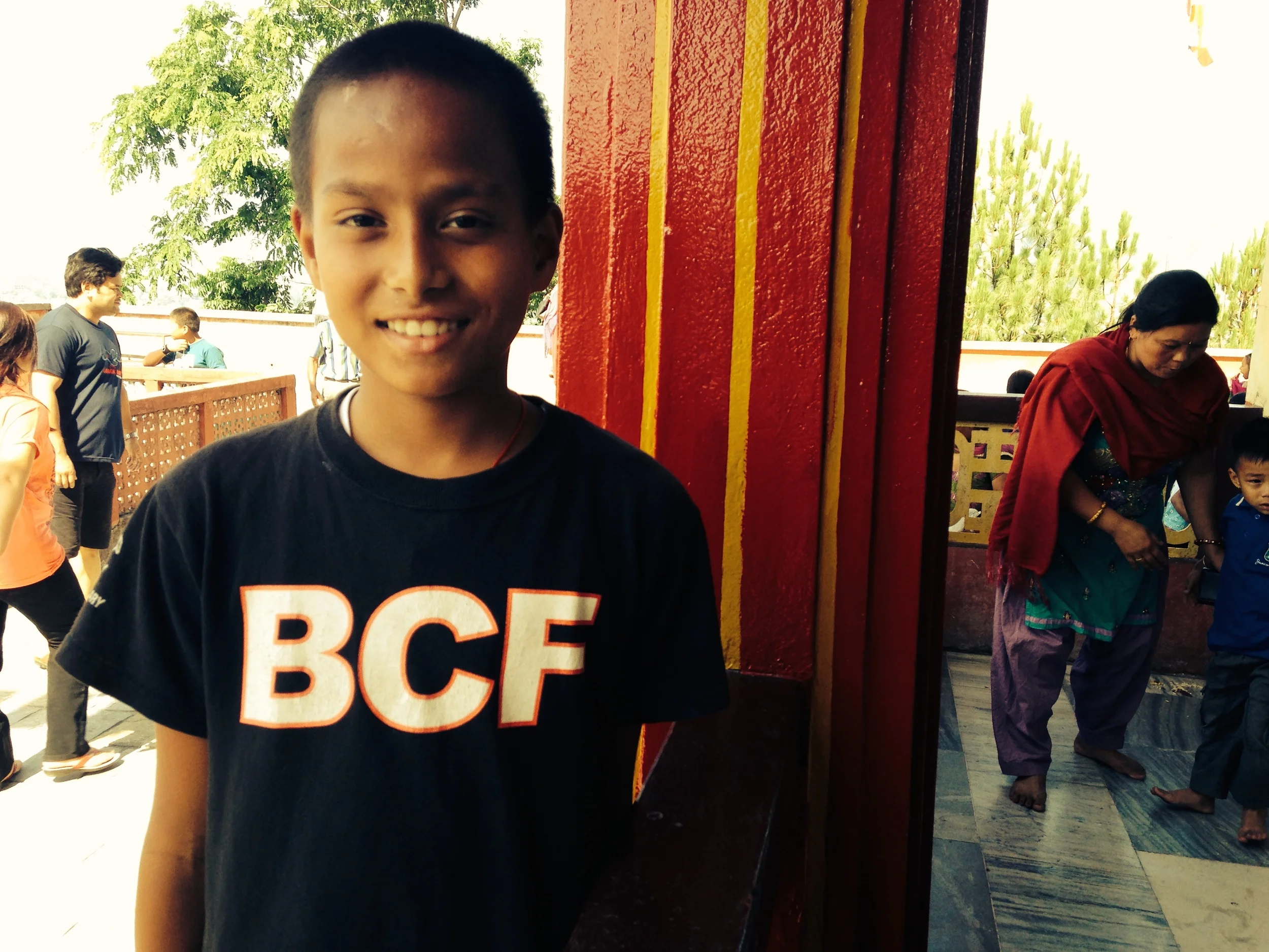 A smiling student proudly sports his new t-shirt from a football club in Colorado, U.S.A.