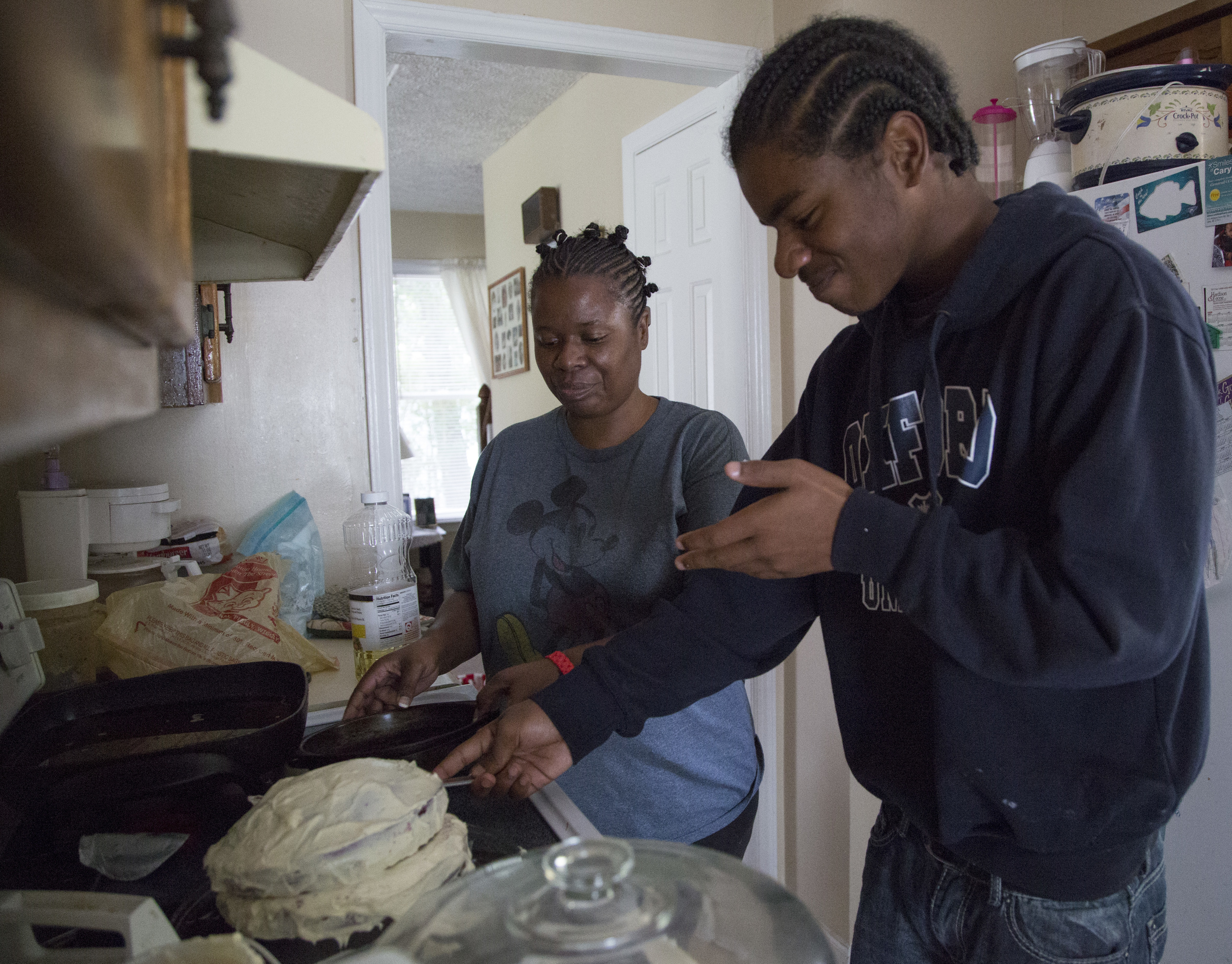Monica Alexander helps her son, McKinley Patterson, 14, make his birthday cake at their home in Zebulon, N.C., on Wednesday, July 23, 2014.