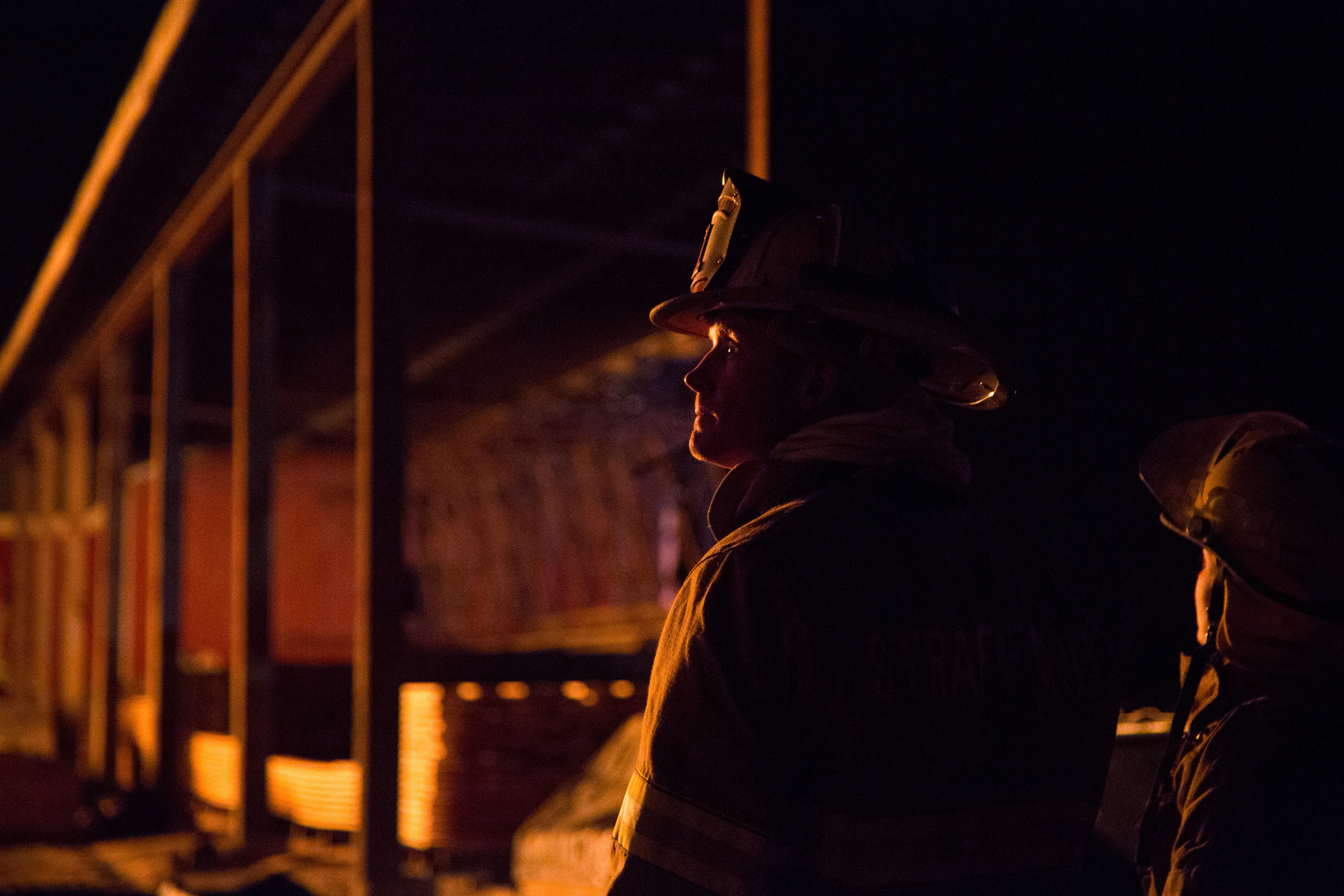  Strafford Fire Chief Jeremiah Linehan watches as firefighters from across the Upper Valley work to extinguish the four-alarm fire that leveled the sawmill building at Britton Lumber Company on Saturday, March 28, 2015. 