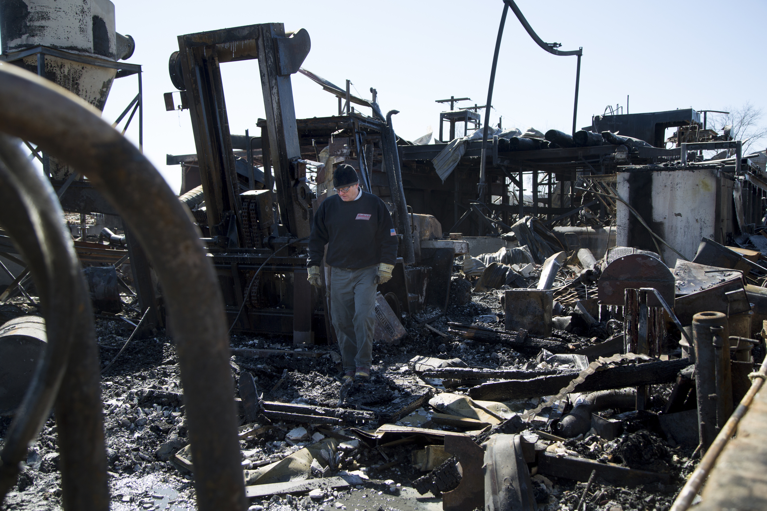  Tom Fulton, of Fairlee, Vt., exits the wreckage of the sawmill building at Britton Lumber Company in Fairlee, Vt.,&nbsp; after turning off the water on Sunday, March 29, 2015. Fulton, the sawmill dry kiln manager, has worked at Britton Lumber Compan