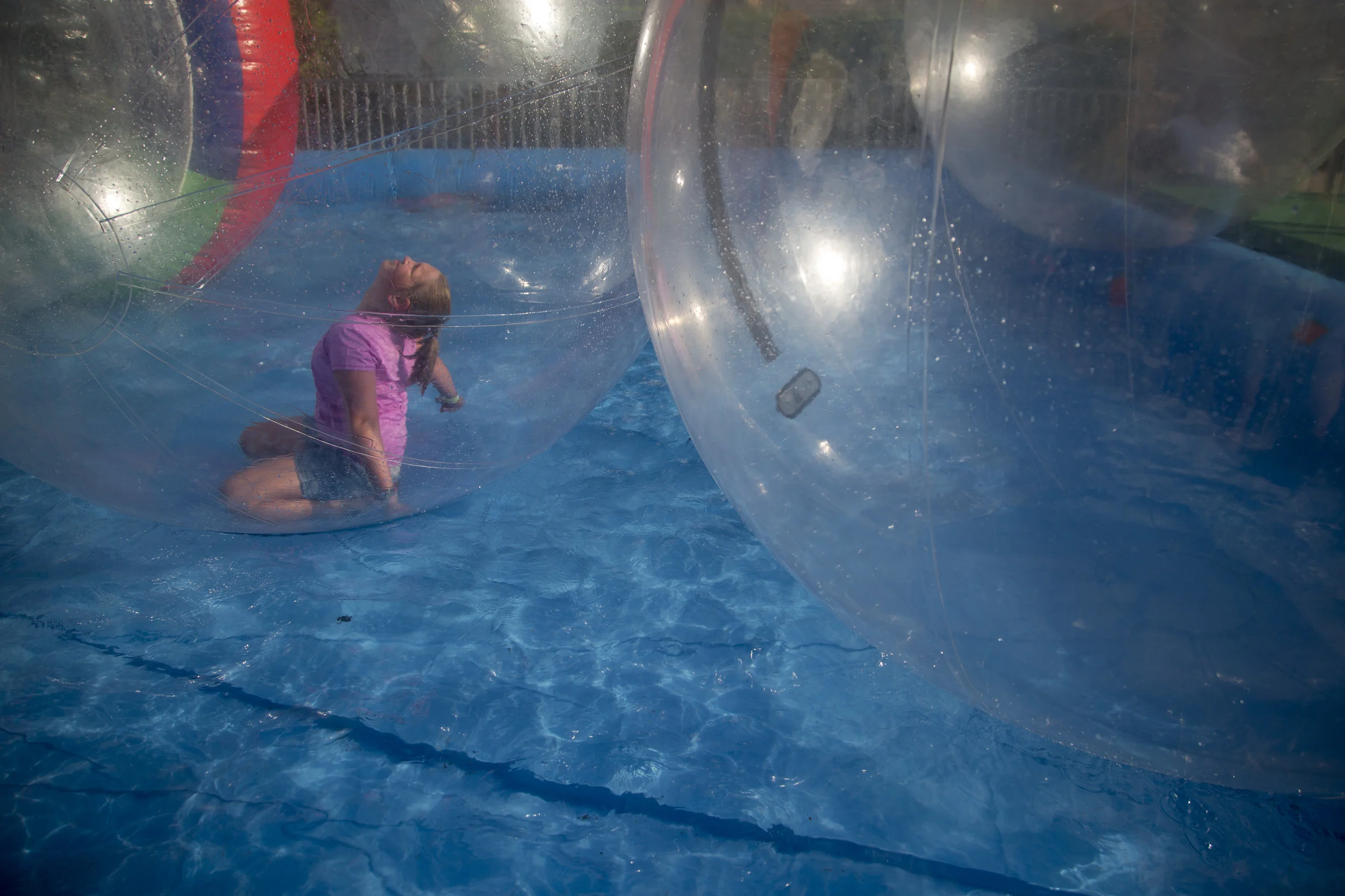 Haliey Eckert of Jasper, 9, floated around a temporary pool in a large blow up ball on Saturday evening at Strassenfest in Jasper. This ride gives kids the chance to feel like they're walking on water or floating on the surface while staying dry.