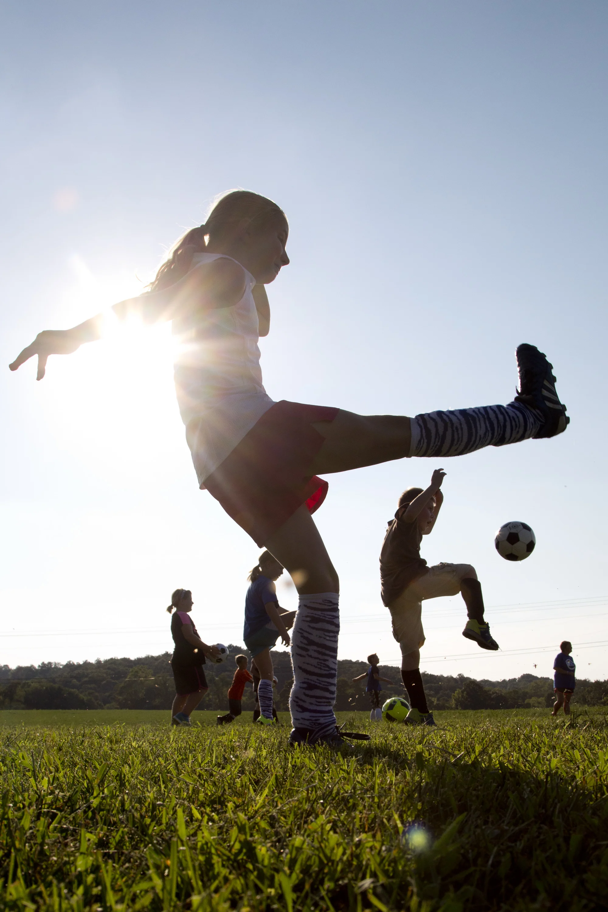 Cassidy Riecker of Celestine, 10, front center, and Elijah Kerby of Nicholson Valley, 9, right, practiced drop kicks with their Northeast Dubois Youth Soccer team, the Thunder, in Celestine on Tuesday.