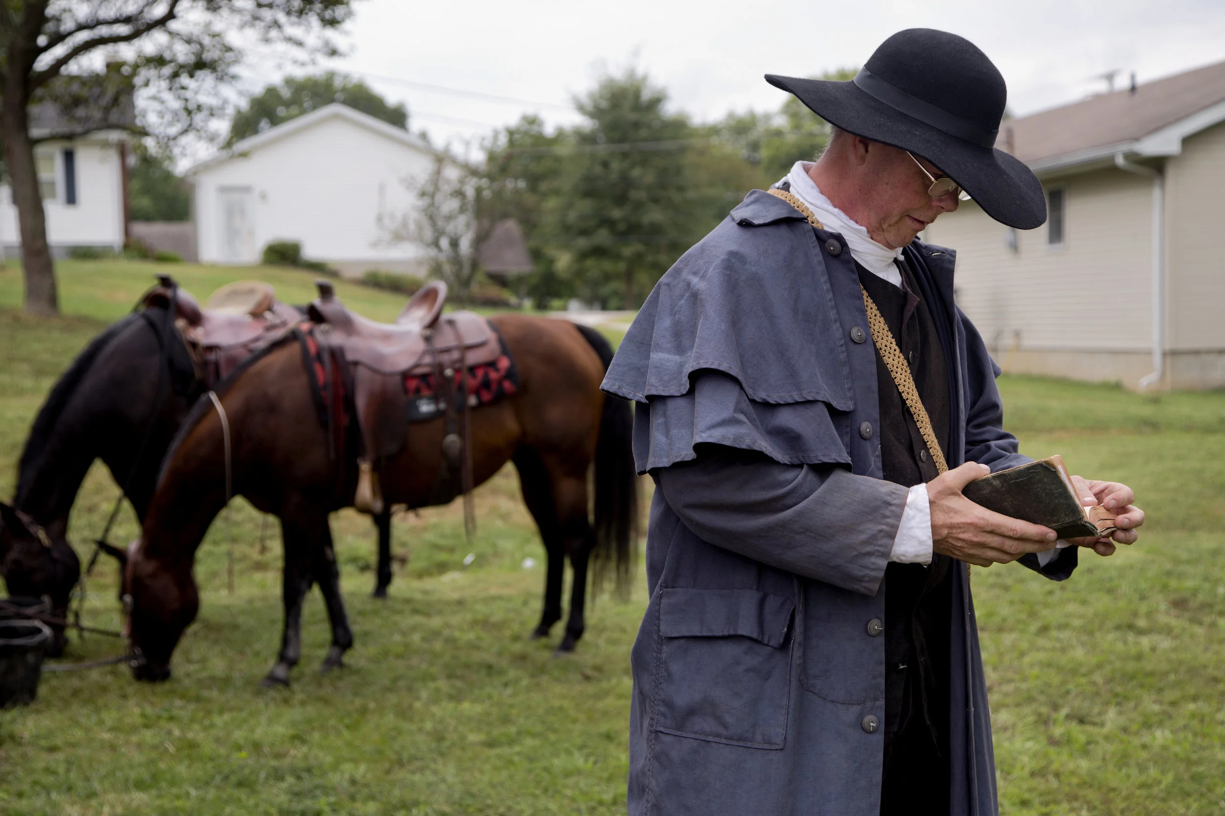 Mike Mulligan of Waxhaw, N.C., thumbed through his bible before preaching at the Cowboys for Christ event at Christ Community Fellowship Church in Huntingburg on Saturday. Mulligan and Calvin Barfield of Conway, S.C., travelled to Huntingburg with their horses, Honey and Sassy, to give rides to kids and preach about Jesus. 