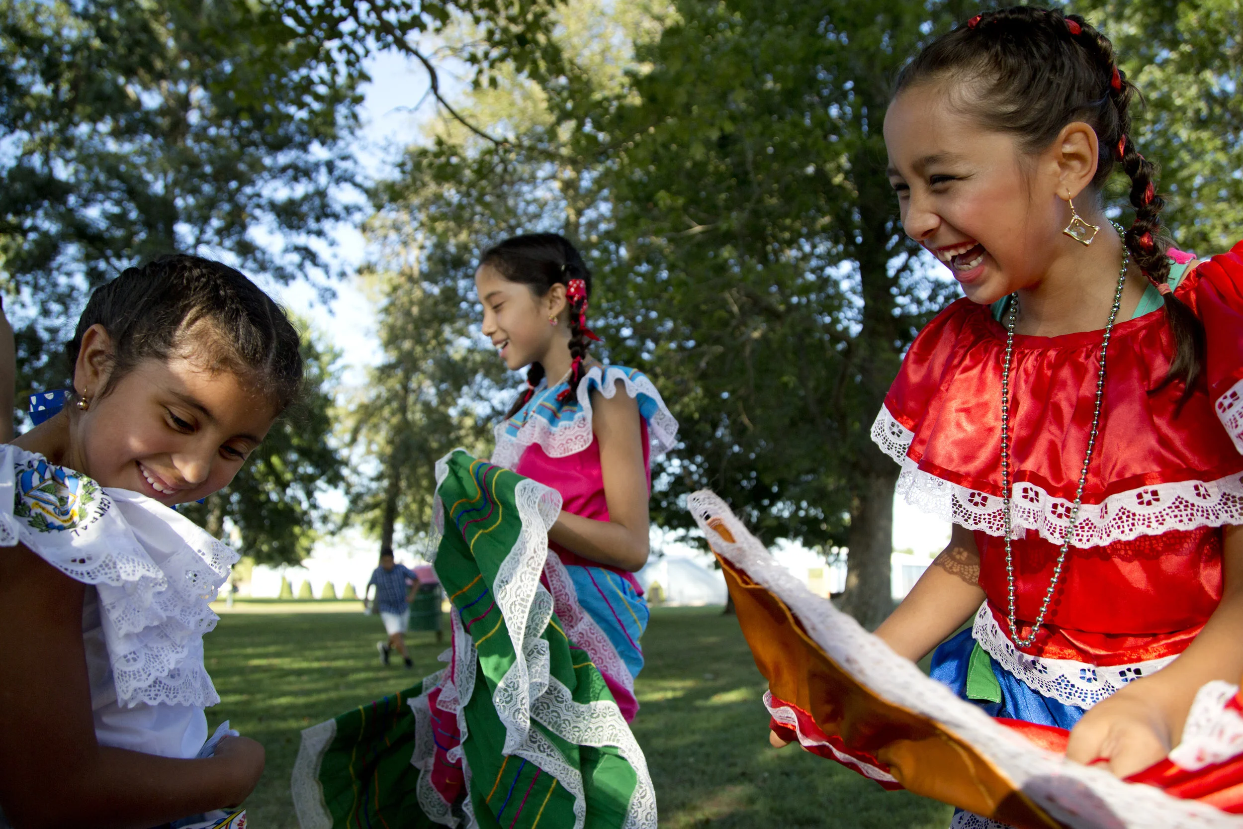 Gabriela Gomez, 6, from left, Jazmin Uresti, 11, and Jaslyn Soto, 8, all of Huntingburg, joked around while waiting to perform a traditional El Salvadoran dance during Latino Fest at Huntingburg City Park in Huntingburg on Saturday.