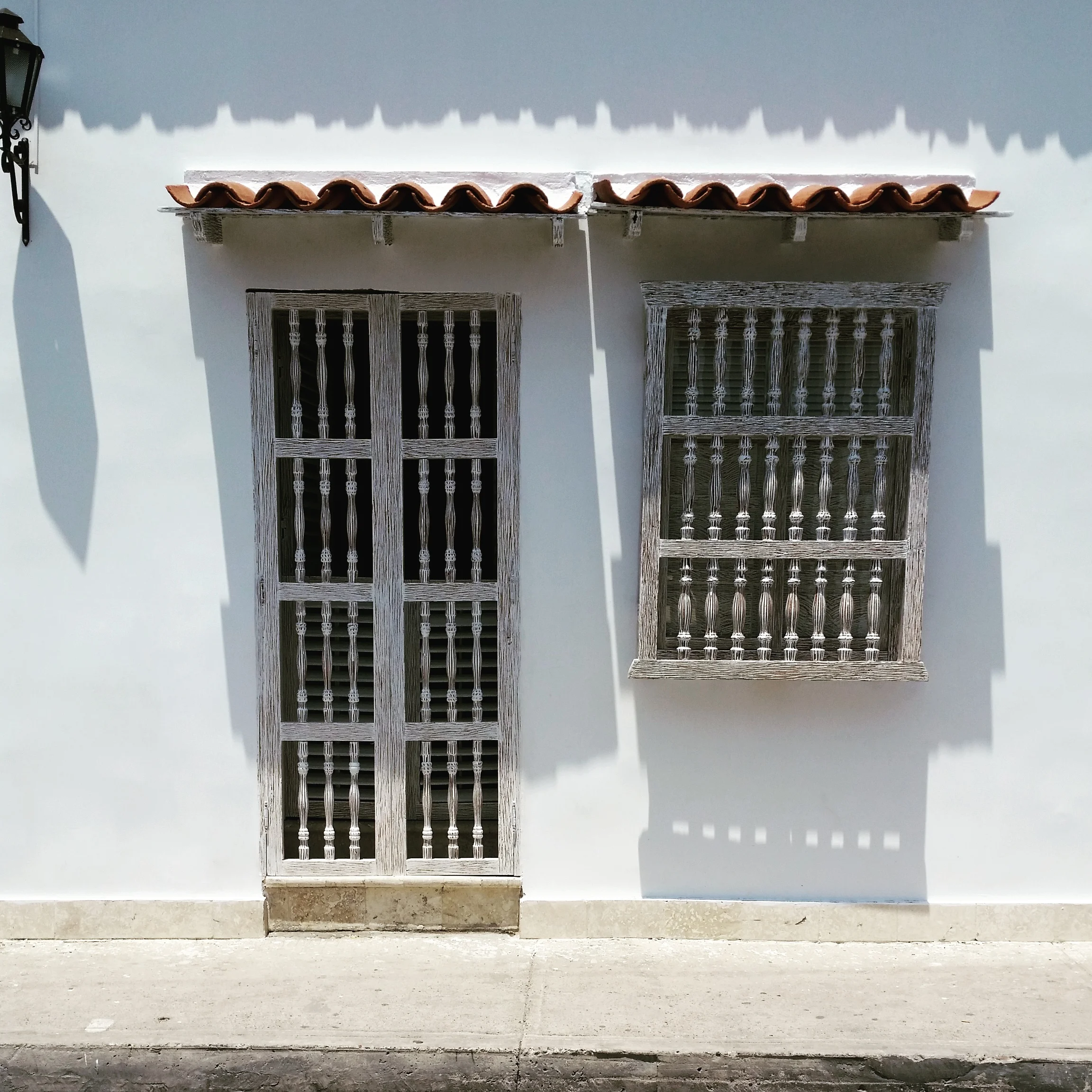 shadows on a wall ; a street scene of a home across from my hotel