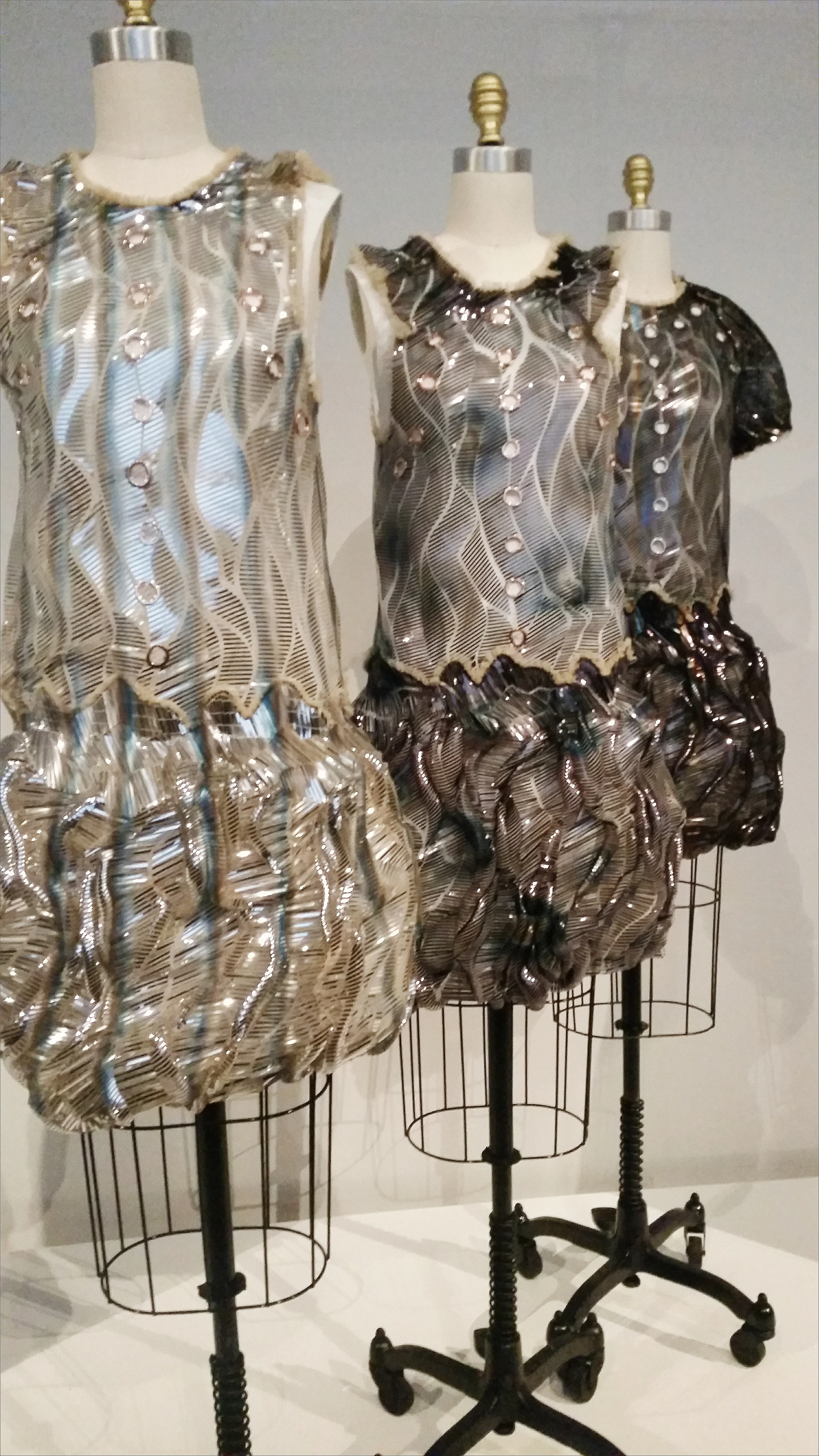"These pieces were very complex in terms of the processes involved. The celluloid sequins were cut into strips by laser, then machine glued onto tulle. When the fabric arrived back from the factory, I didn't like it - I thought the tulle was too flat - But, as I began to fold and drape the fabric, bubbles began to form, and the sequins took on the shape of a croissant...Because the sequins were too shiny, we had them spray-painted - by hand - to create shadows and to make them look more dimensional...I wanted everything to look imperfect, even the metal eyelets." - Nicolas Ghesquiere