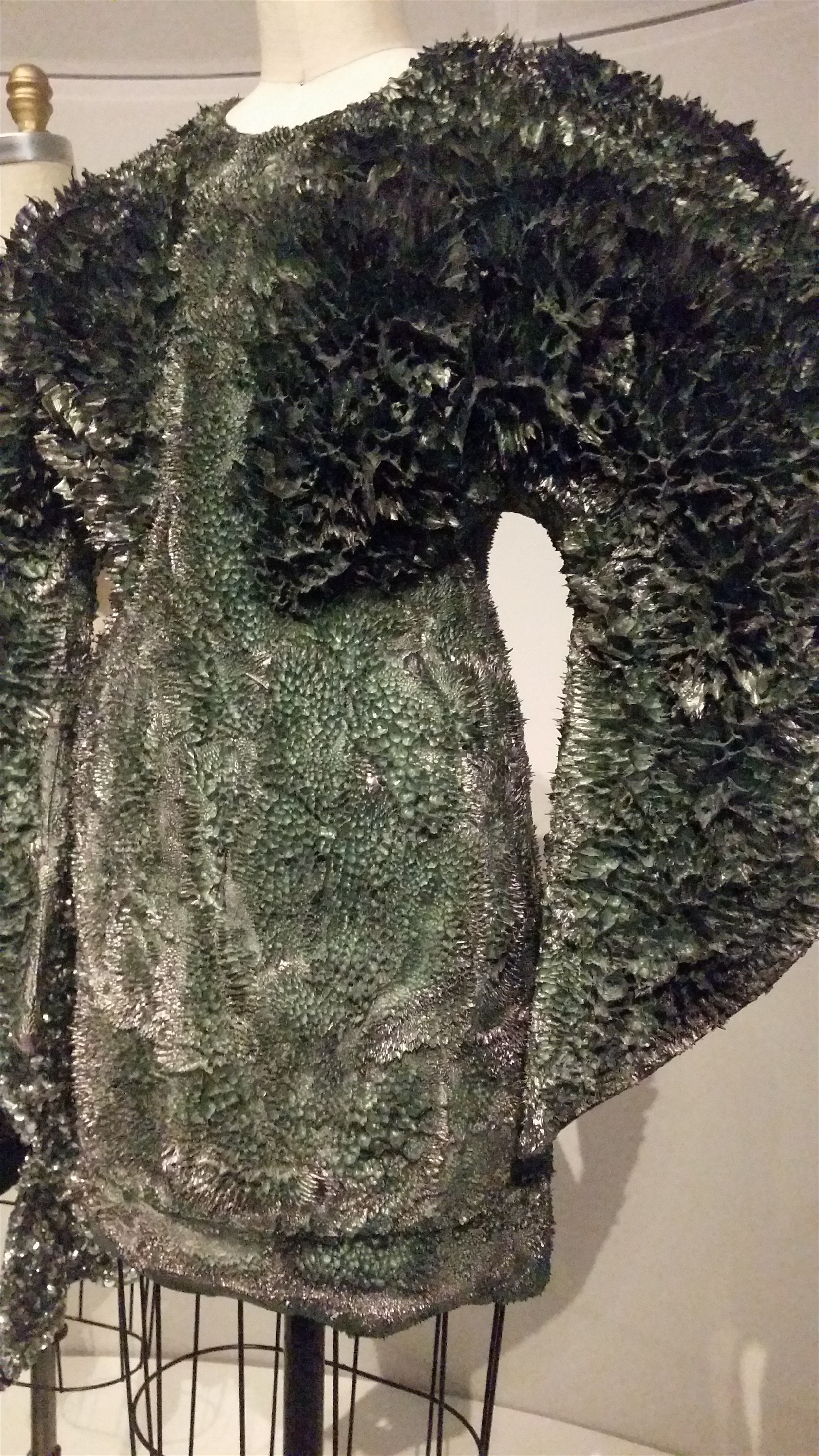 "This dress has a base made from cotton fabric. Then there is a rubber component - a soft rubber - in which we place metal powder. When you mix everything together, the rubber has a few minutes when it is still wet and soft. We pour the rubber onto the cotton fabric. Then we place magnets above and below, and you see the metal powder grow piece by piece - in a matter of seconds - before it sets. The coloration is exquisite because while the rubber is still wet and soft we add a very thin enamel powder that has iridescent qualities." -Iris van Herpen