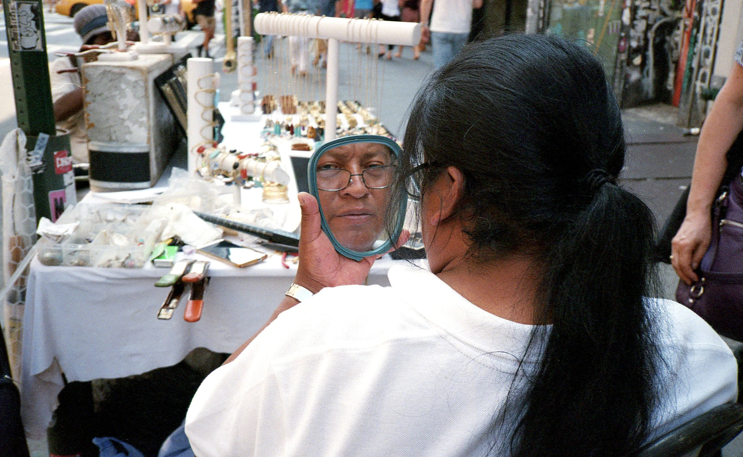 woman looking in hand mirror.jpg