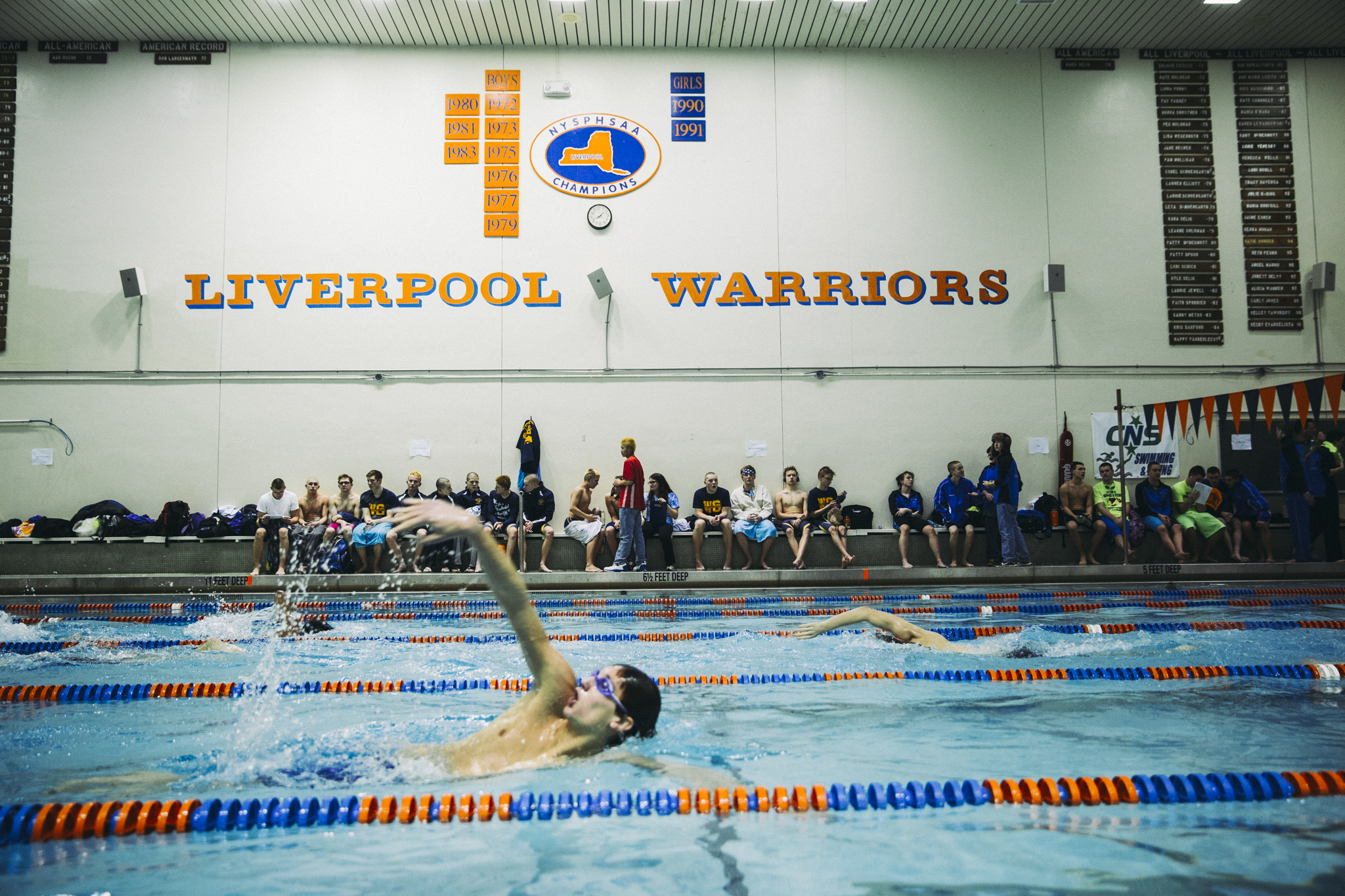 Jacob Fauret, a senior from Watertown swims warmup laps during a break at the Section 3 Boys A Championship Meet at Liverpool High School. Watertown dominated the first half of the meet, and placed second on the evening. 