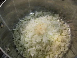 ADD OLIVE OIL, ONIONS, FENNEL AND GARLIC TO A LARGE POT, COOK UNTIL ONIONS ARE TRANSPARENT
