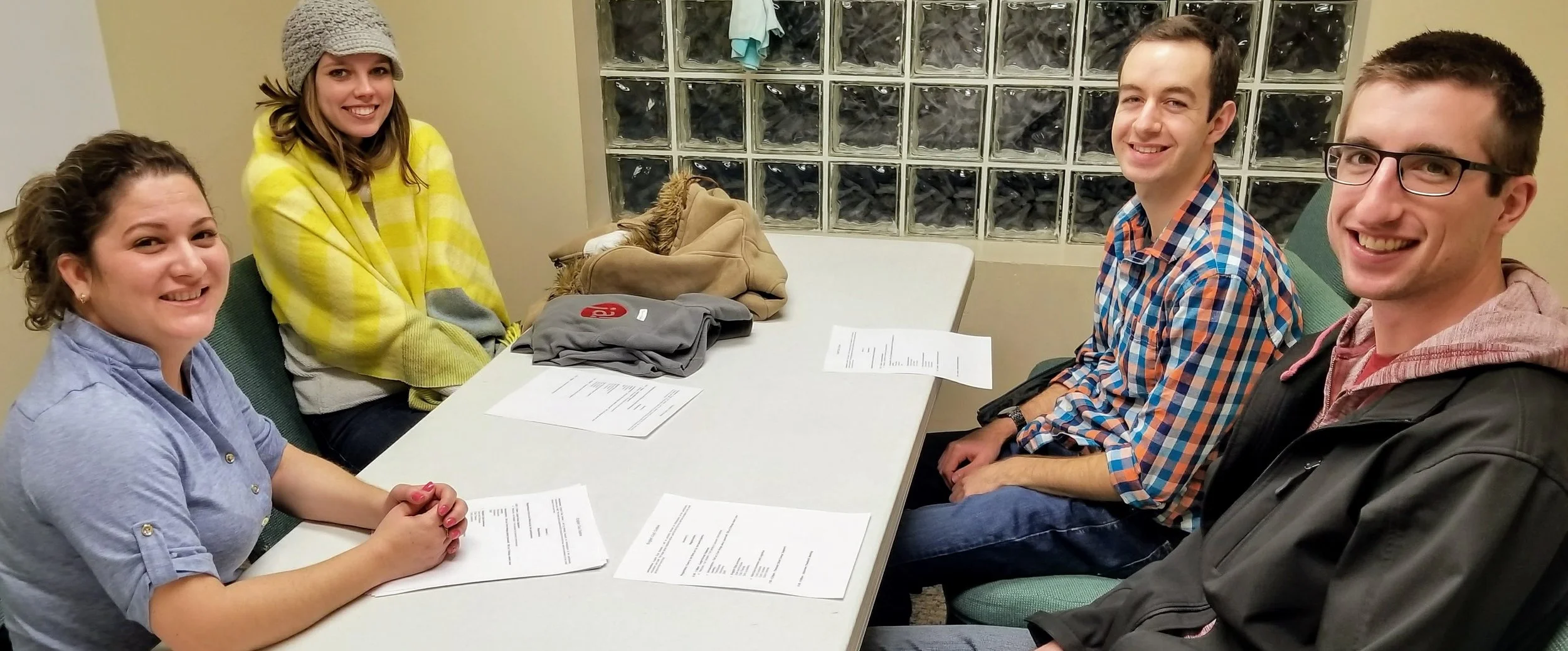 Cody (far right) and Joanna (yellow sweater) participate in a planning session for English Club.