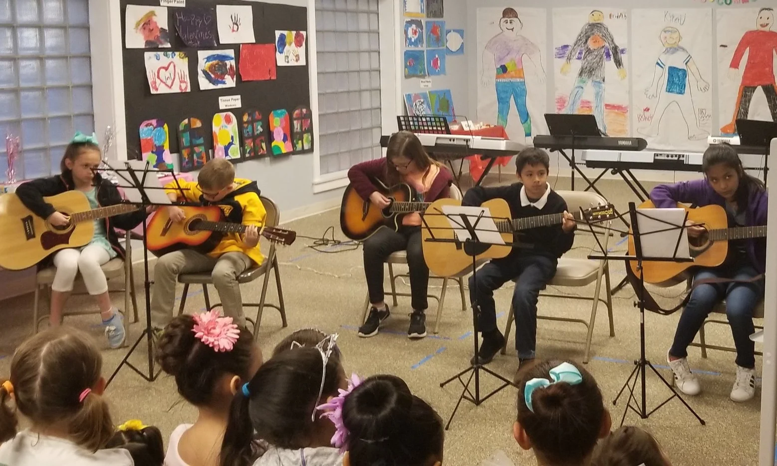 The guitar class performing at the trimester party.