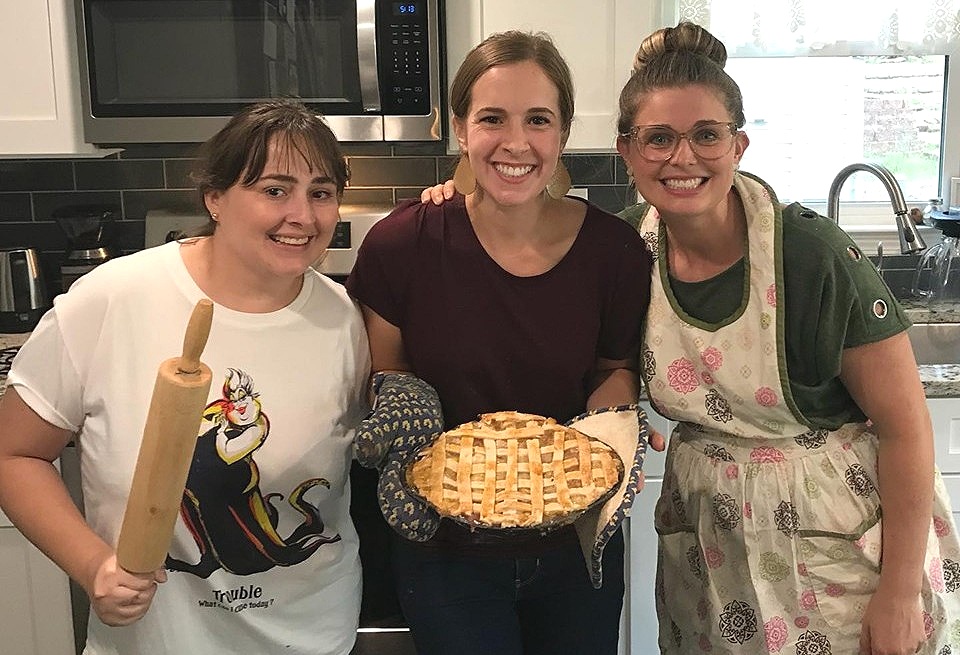 Leidy, Kristen, and Ruth (from left to right) sharing life together while baking a traditional American fruit pie.