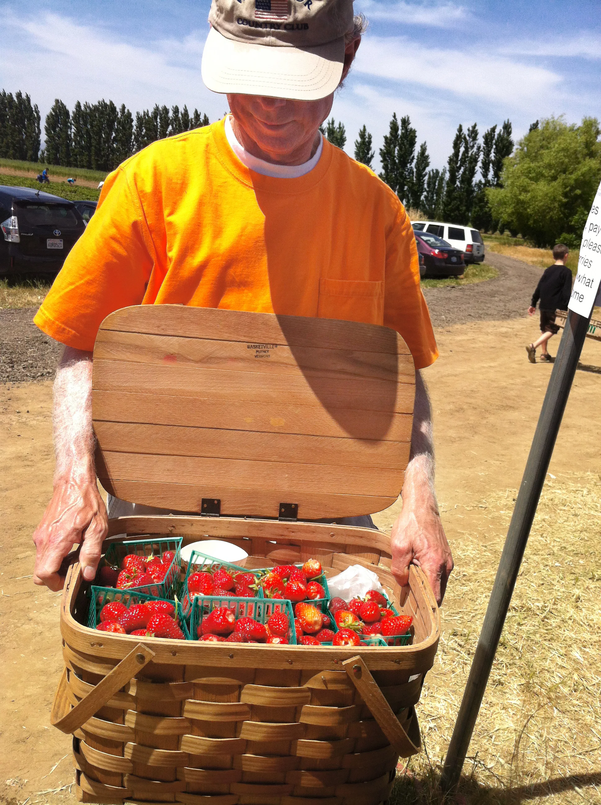 John with his basket full of freshly picked strawberries at an Eatwell Farm Strawberry Day event.
