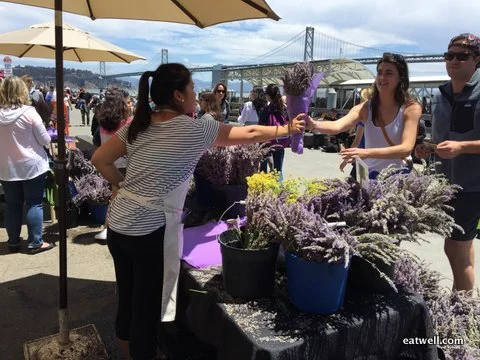 Joyce sells bunches of fresh lavender to Ferry Plaza Farmer's Market customers on Saturday.