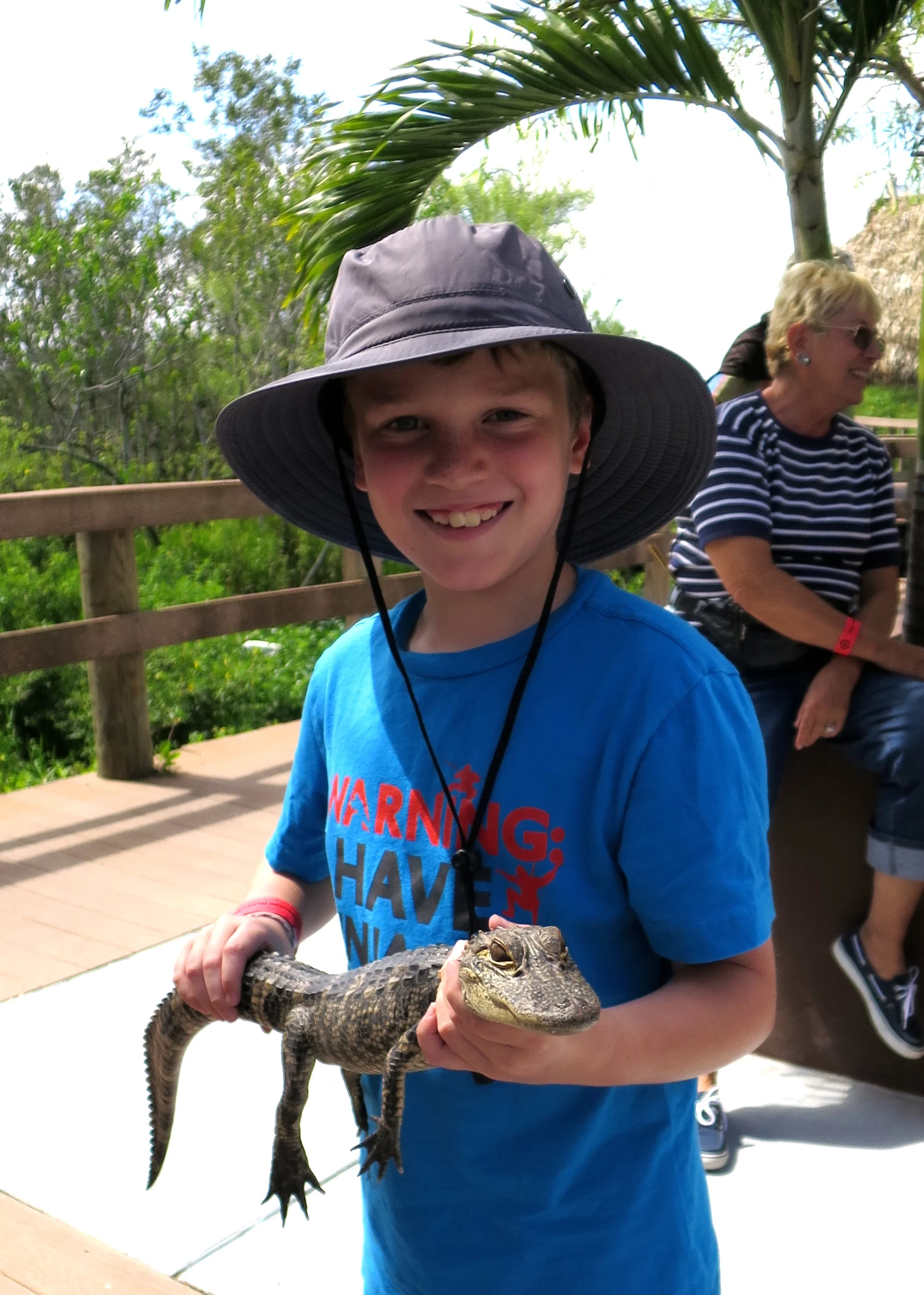 This is a three-year-old alligator with an eight-year-old Doyle at the Miccosukee Indian Village in the Everglades.