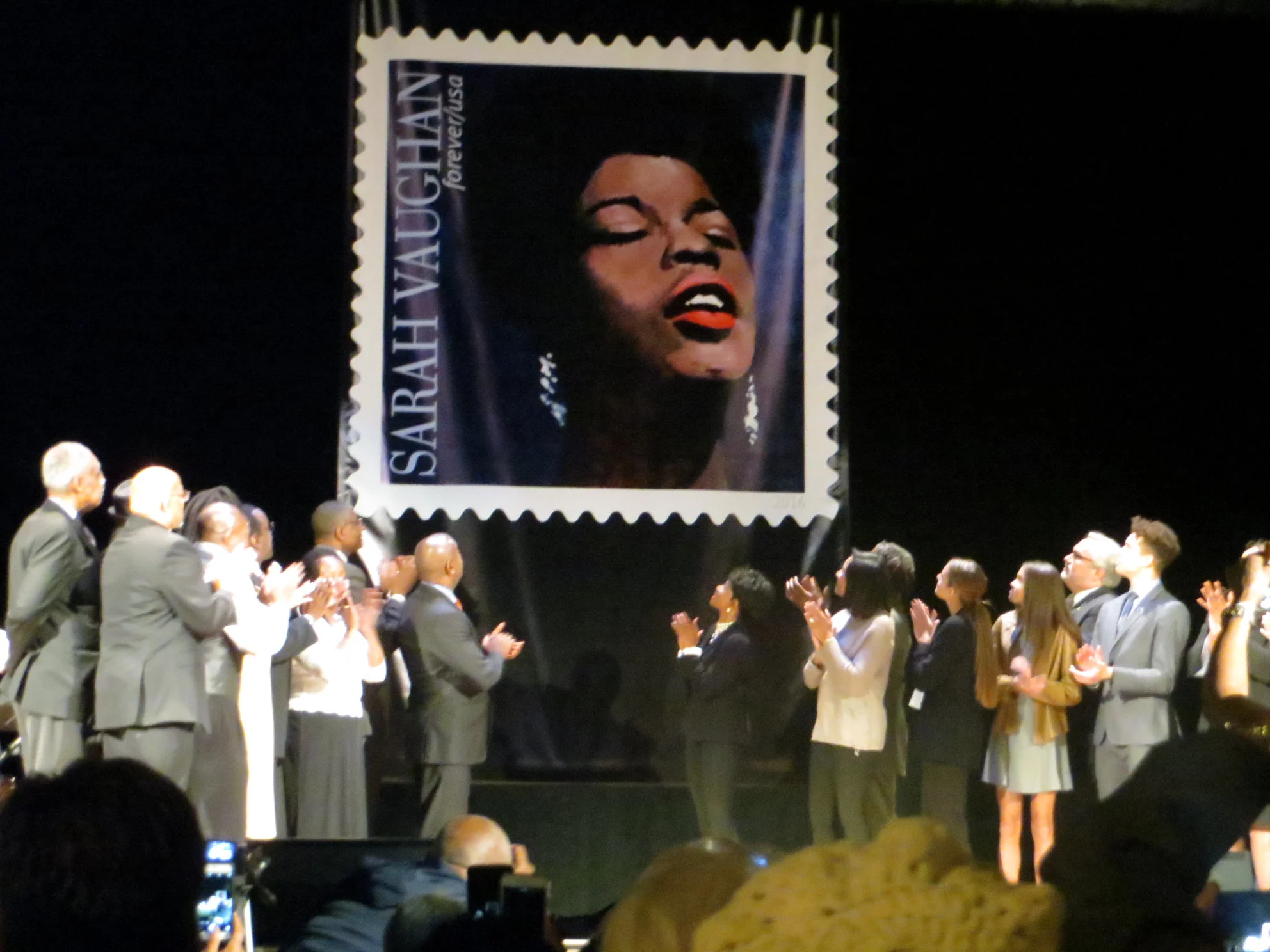 Special Guests of the event applaud at the unveiling of the Sarah Vaughan USPS Forever Stamp.