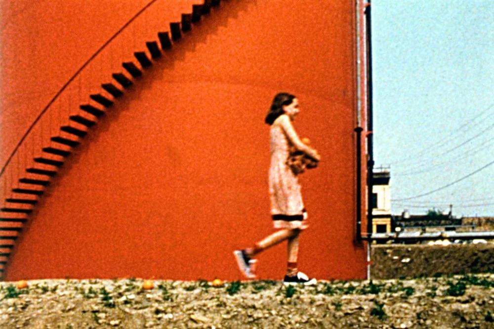 04-one-way-boogie-woogie-1978-001-girl-walking-past-red-wall.jpg