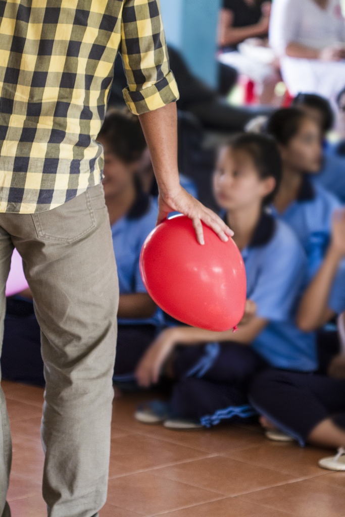Kuur, of Sports Friends, Thailand, prepares to toss a balloon, containing a quiz question about HIV, into the audience of teenagers at the Mae Rim Juvenile Correction Facility near Chiang Mai. 