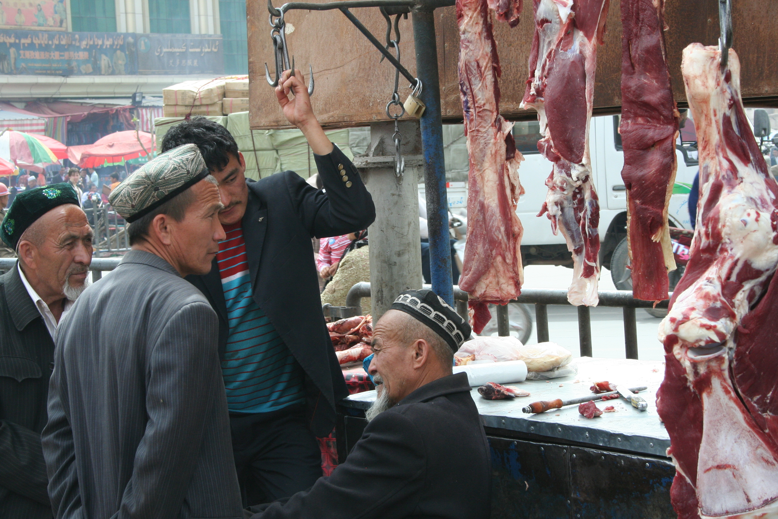 Some Muslim minority men at a butcher in Western China. - Photo courtesy of Kaj Iverson