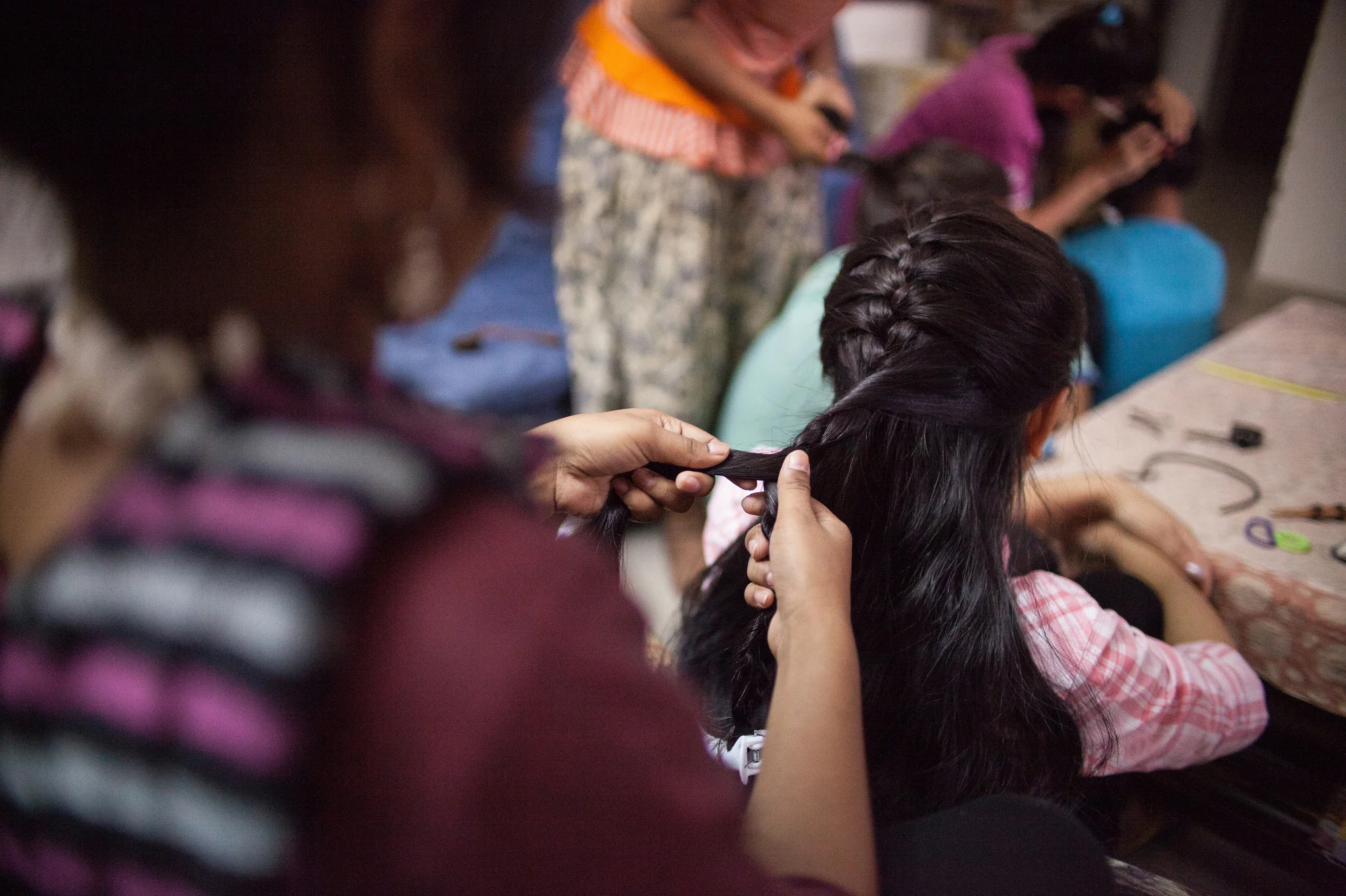 The girls gather in a circle and braid each other’s hair. This simple act of care underlies the deeper kinship in the home. "I feel I am part of a family,” Aarohi said. 