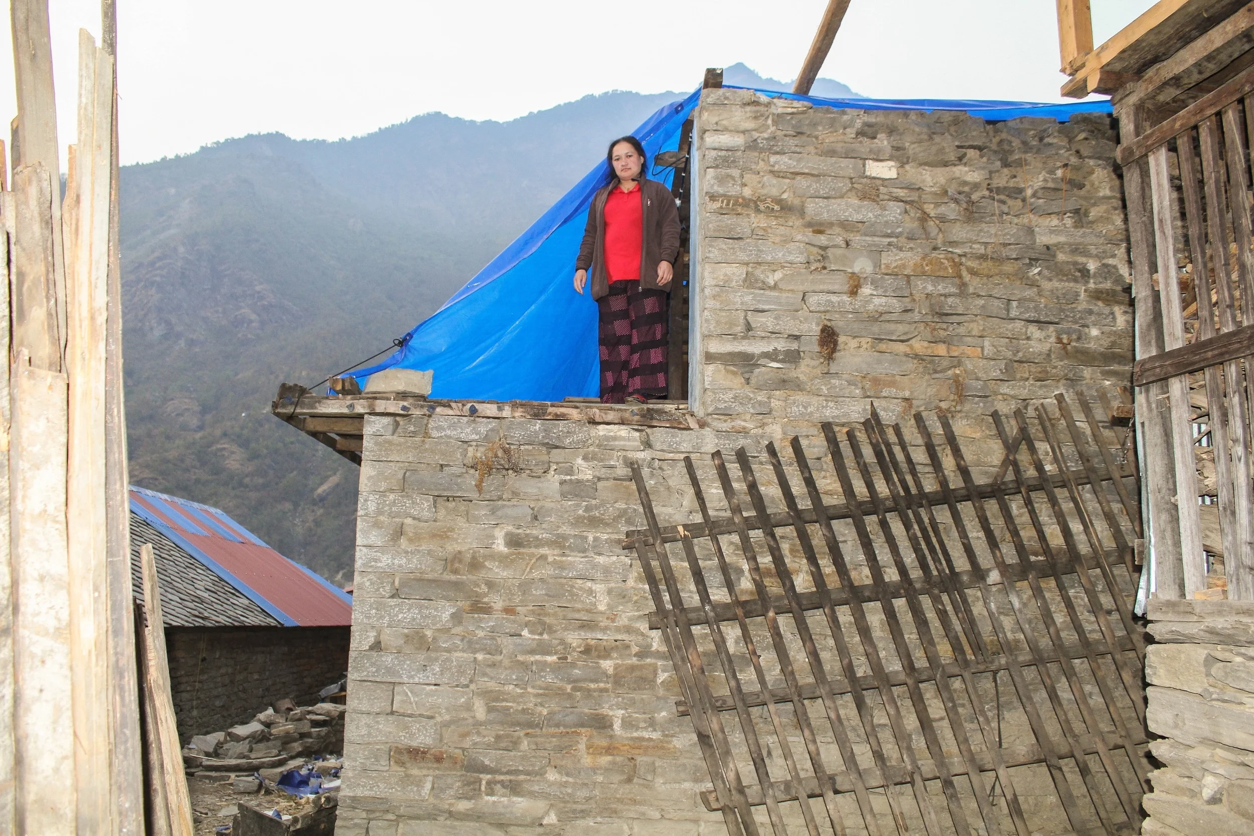 In the village of Tawal, also in Dhading district, many are still living in temporary shelters, or have made use of tarpaulin to cover exposed parts of their homes - Photo courtesy of Ramesh Man Maharjan.